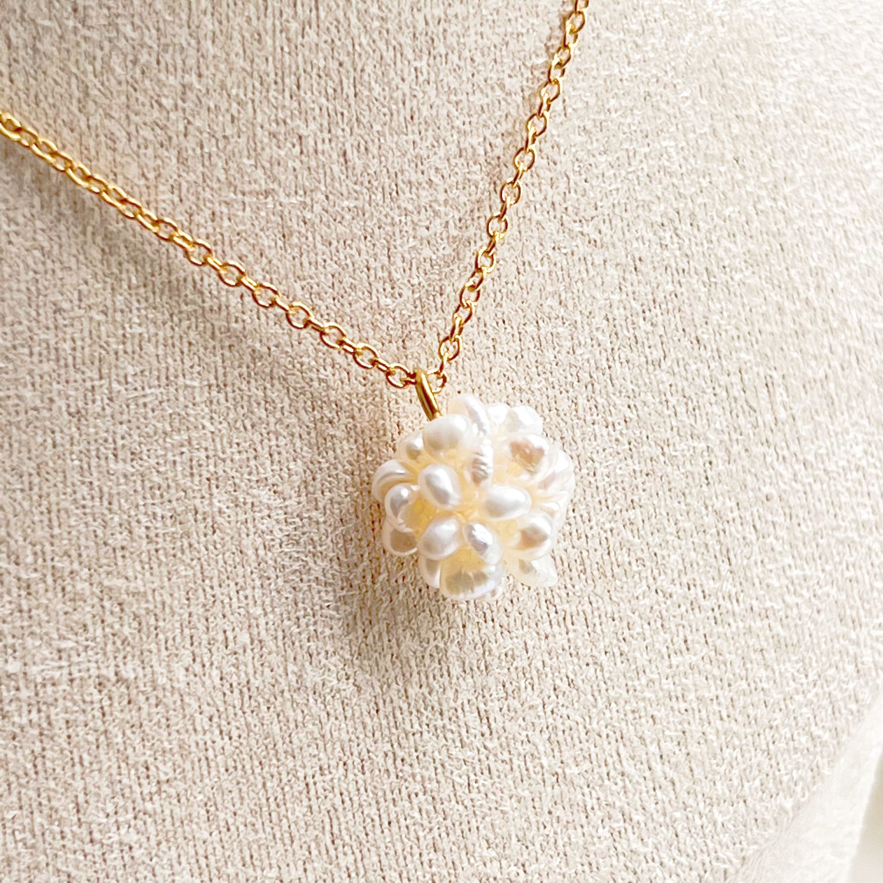 A delicate Small Freshwater Pearl Globe Necklace featuring baroque pearls on a gold-plated chain, elegantly displayed in a gift box.