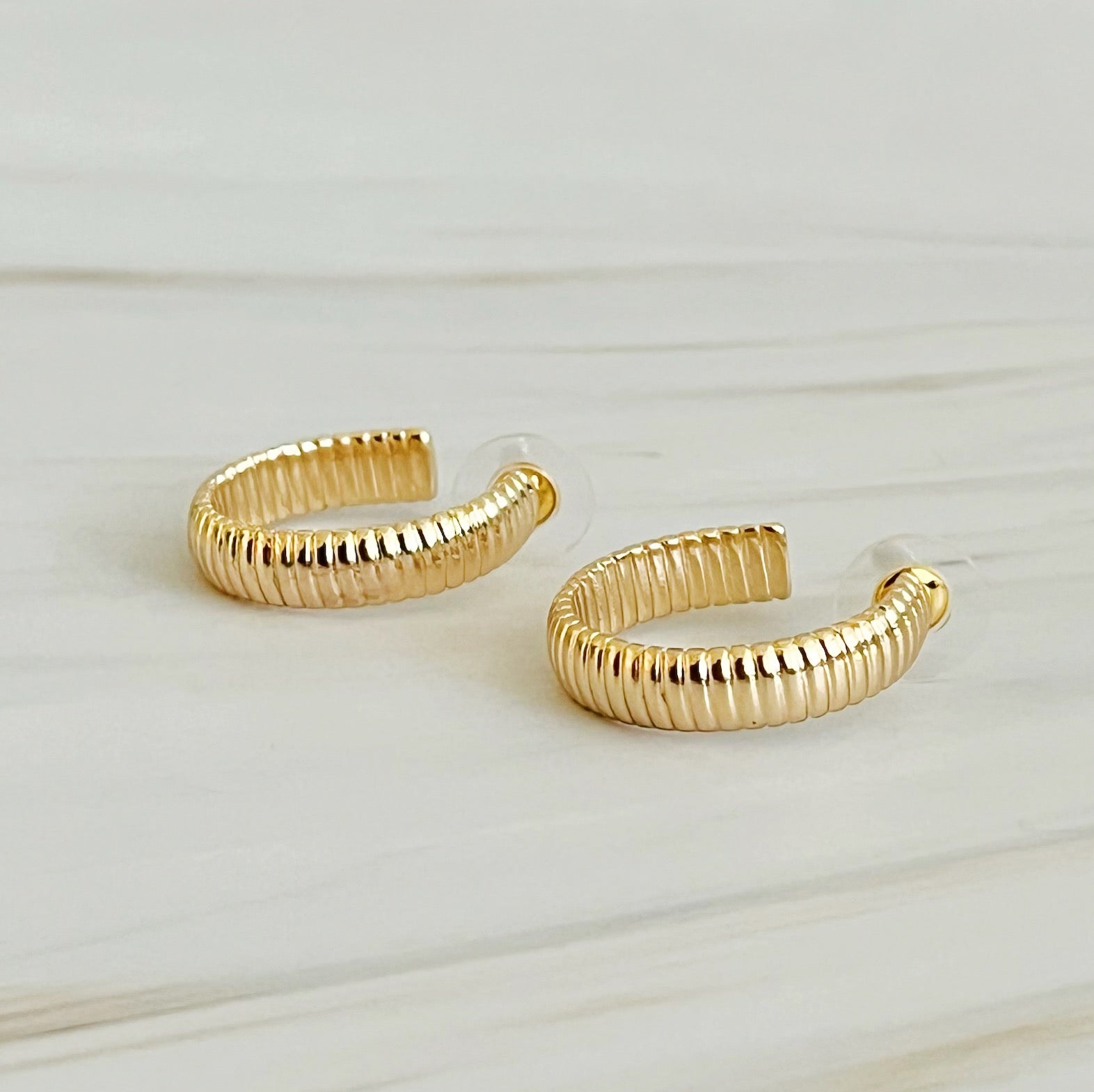 Small Lux Cabled Golden Hoop Earrings featuring a unique cabled design, perfect for adding elegance to any outfit.