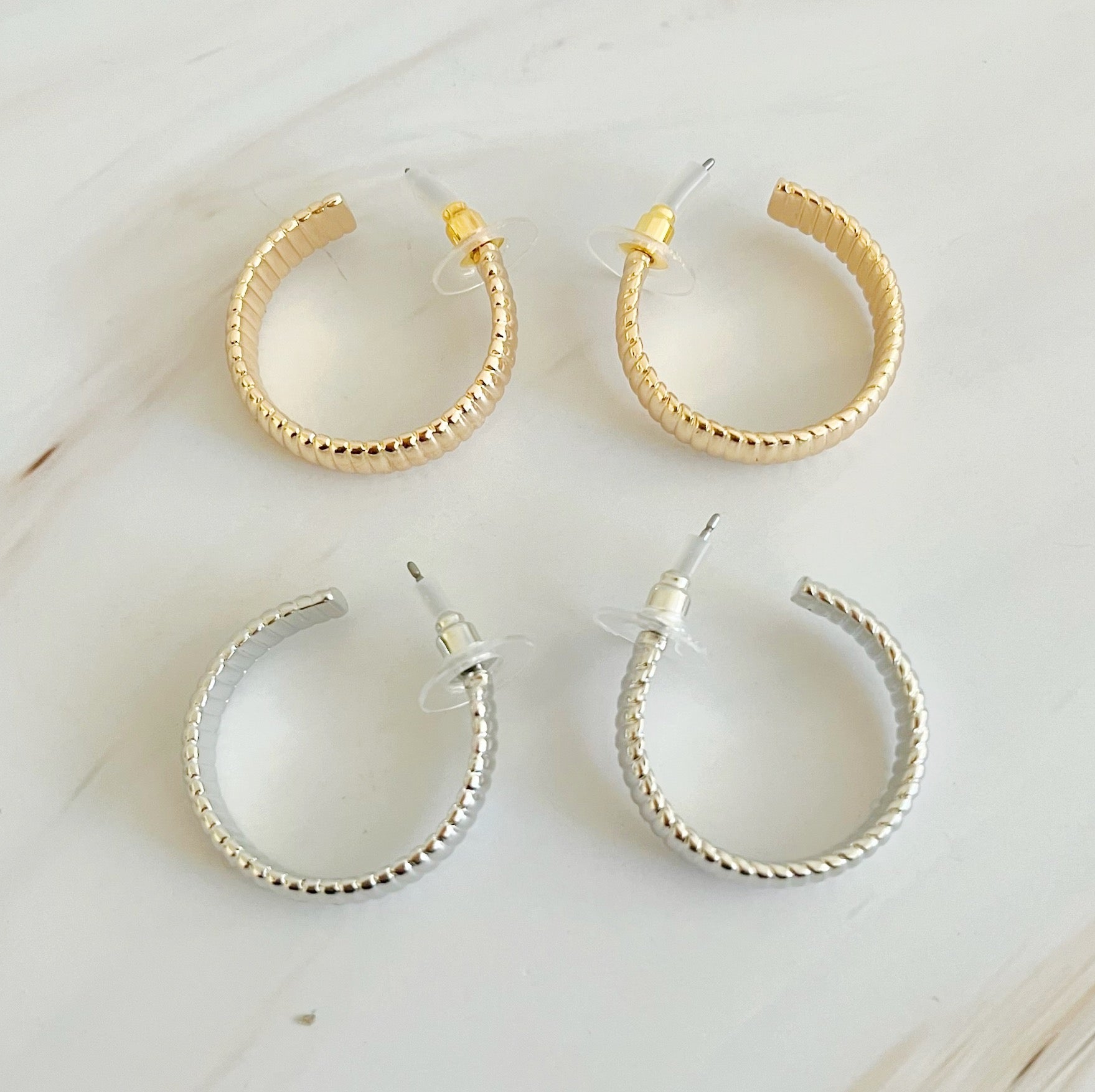 Small Lux Cabled Golden Hoop Earrings featuring a unique cabled design, perfect for adding elegance to any outfit.