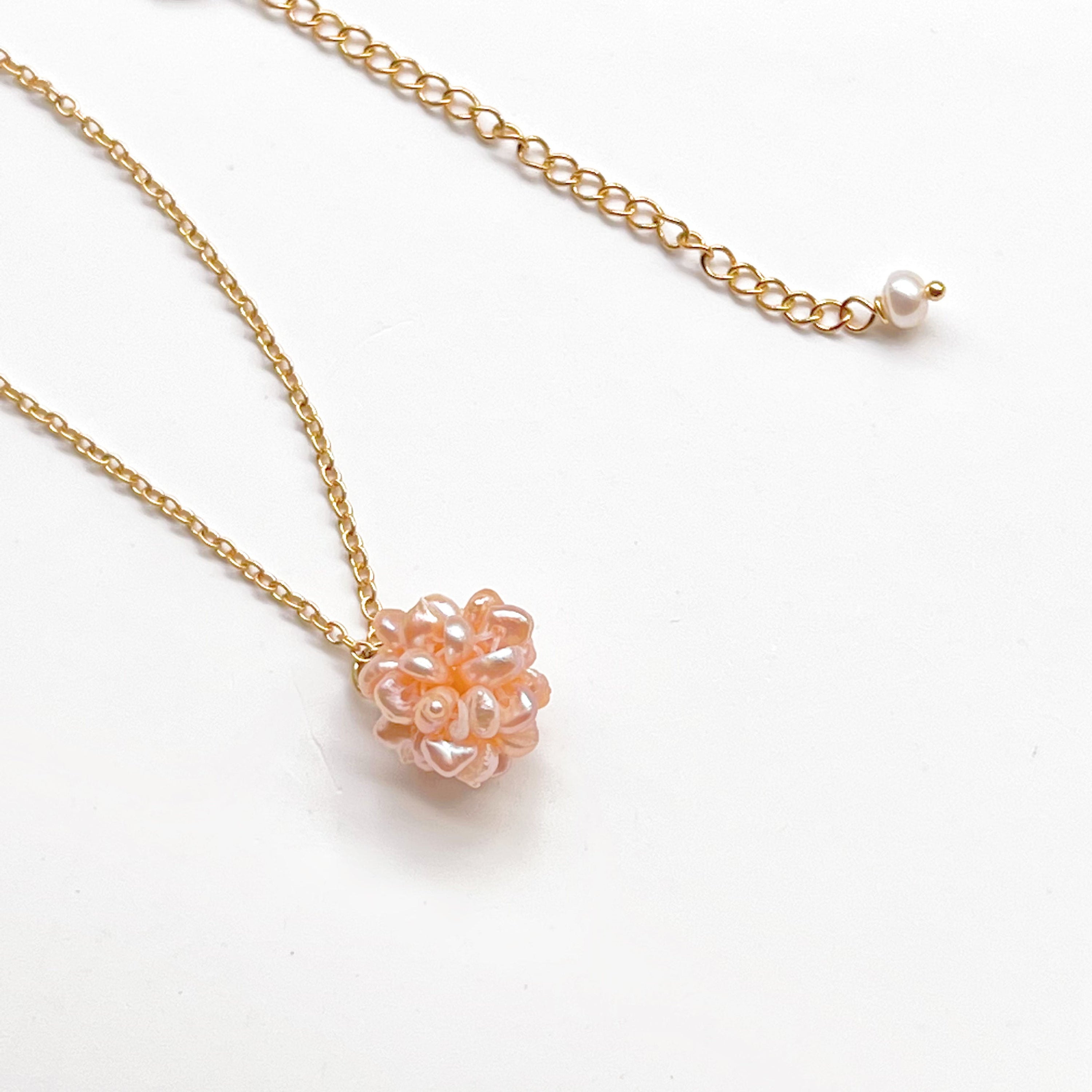 A delicate Small Pink Freshwater Pearl Globe Necklace featuring baroque pearls shaped into a globe, with a gold-plated chain.