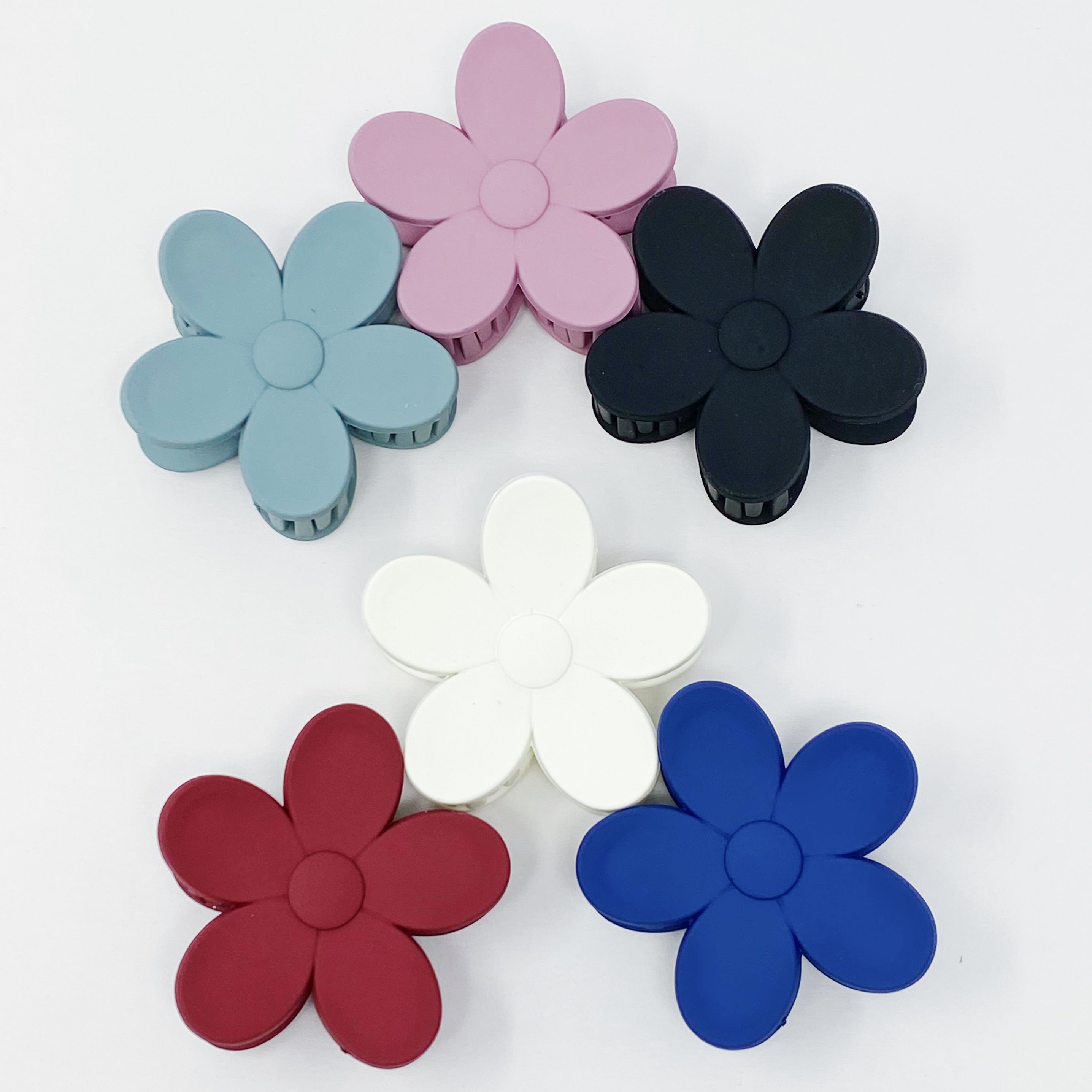 Set of three flower-shaped acrylic hair claws in soft matte finish, showcasing elegant colors for everyday wear.