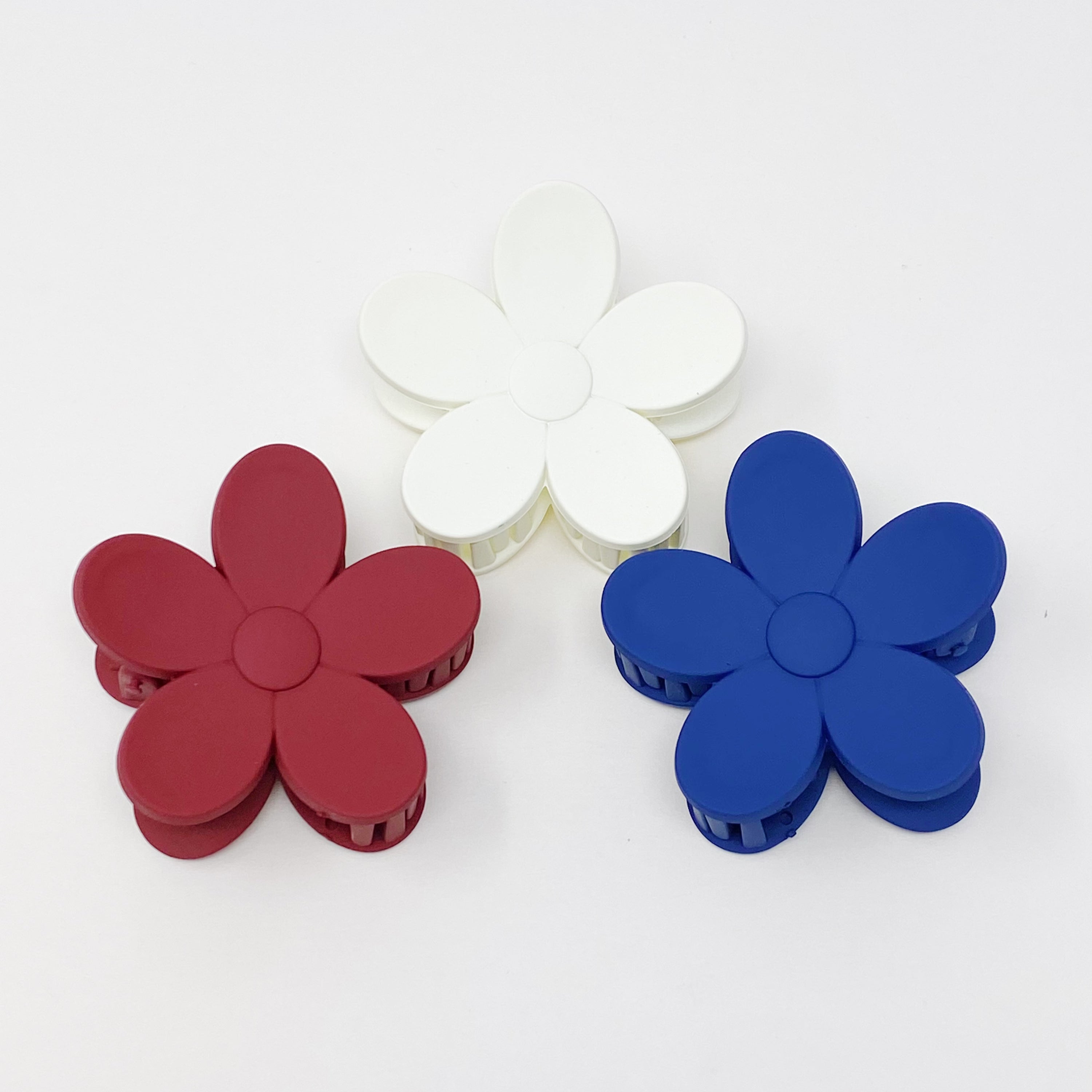 Set of three flower-shaped acrylic hair claws in soft matte finish, showcasing elegant colors for everyday wear.