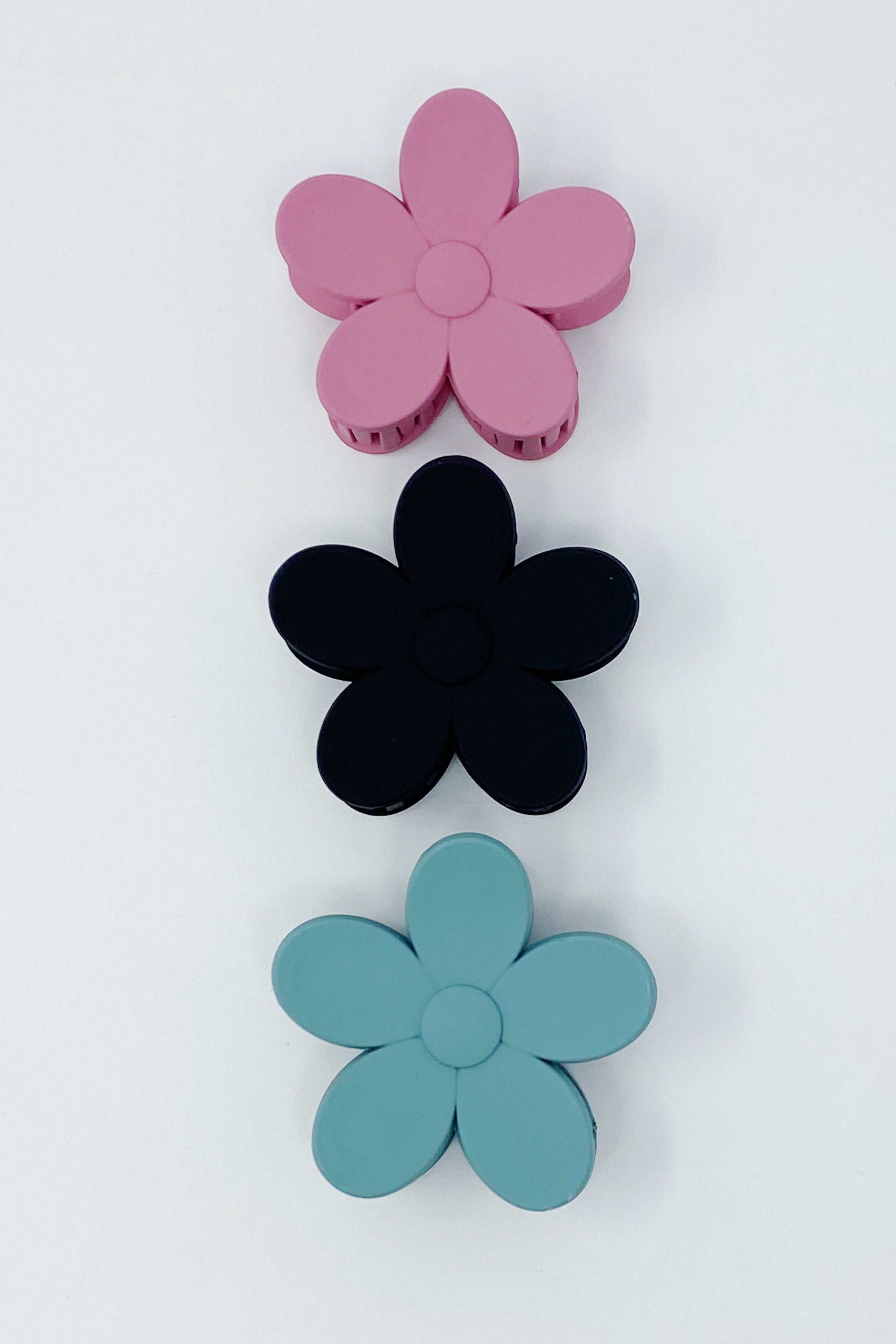 Set of three flower-shaped acrylic hair claws in soft matte finish, showcasing elegant colors for everyday wear.