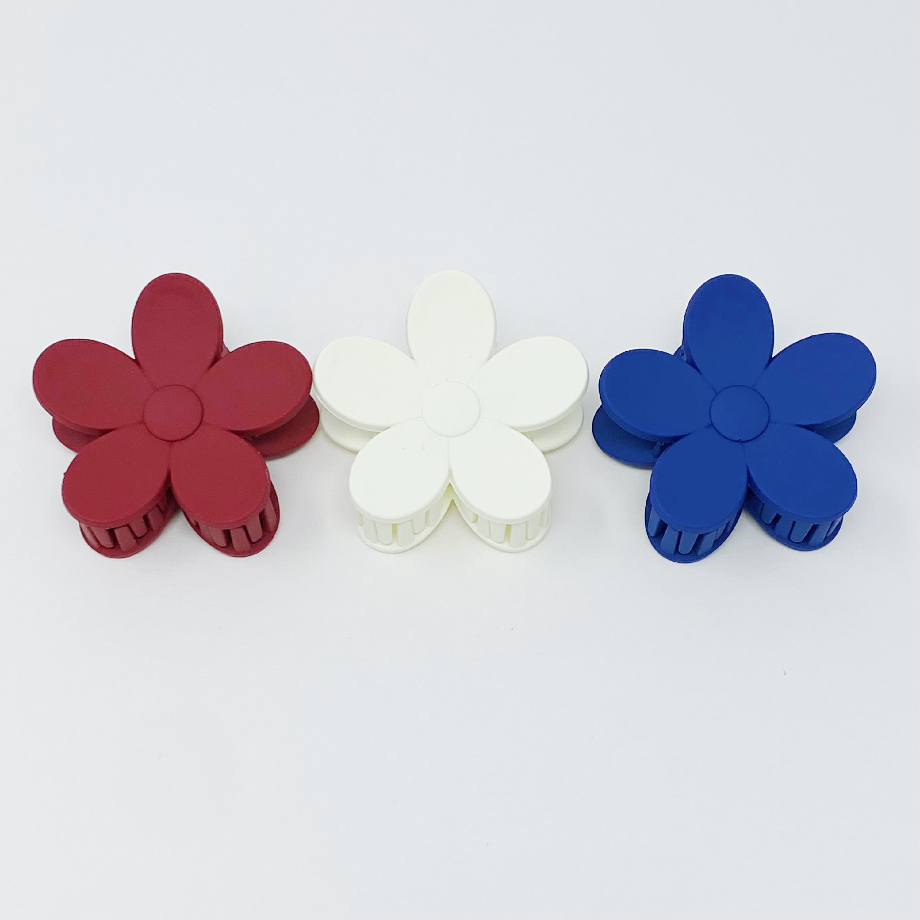 Set of three flower-shaped acrylic hair claws in soft matte finish, showcasing elegant colors for everyday wear.