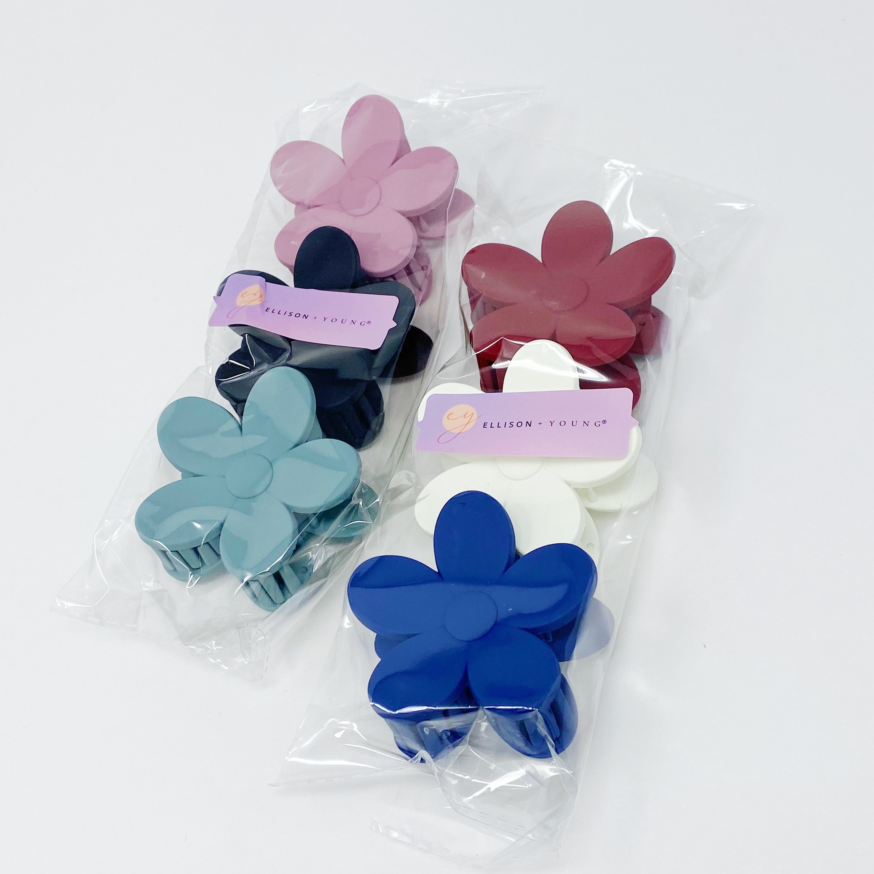 Set of three flower-shaped acrylic hair claws in soft matte finish, showcasing elegant colors for everyday wear.