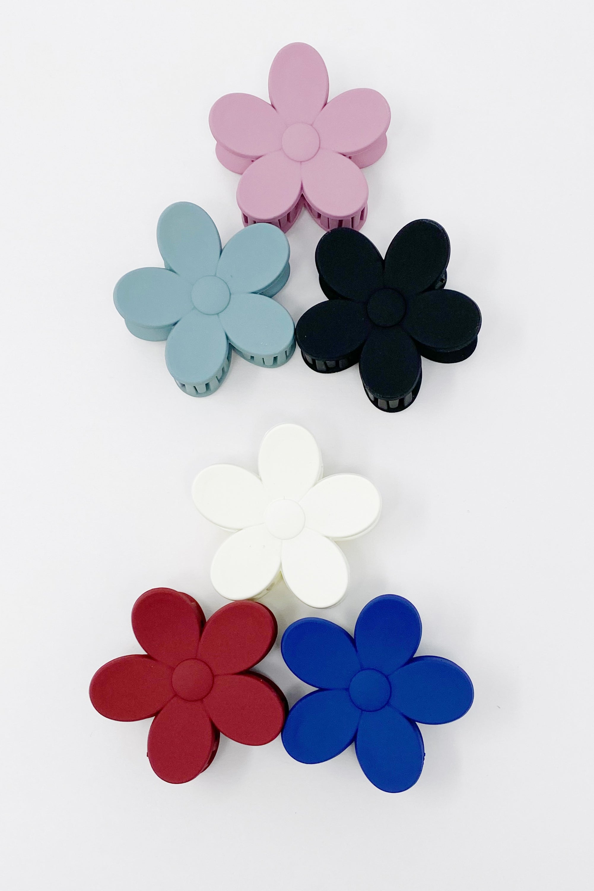 Set of three flower-shaped acrylic hair claws in soft matte finish, showcasing elegant colors for everyday wear.