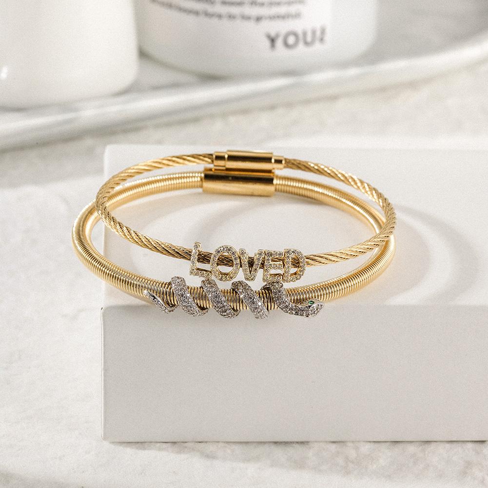 Snake Coiled Loved Pavé Bangle Set featuring cubic zirconia accents and a magnetic closure, elegantly displayed in a gift box.