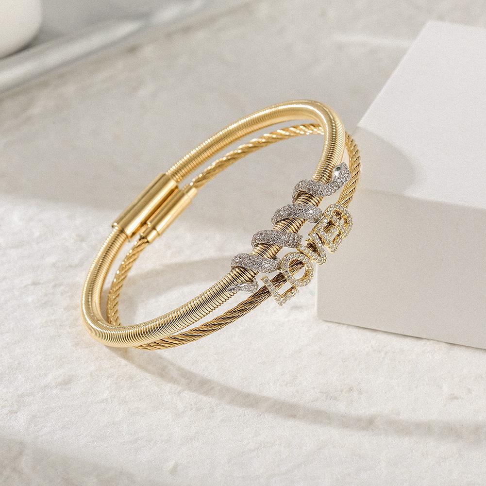 Snake Coiled Loved Pavé Bangle Set featuring cubic zirconia accents and a magnetic closure, elegantly displayed in a gift box.