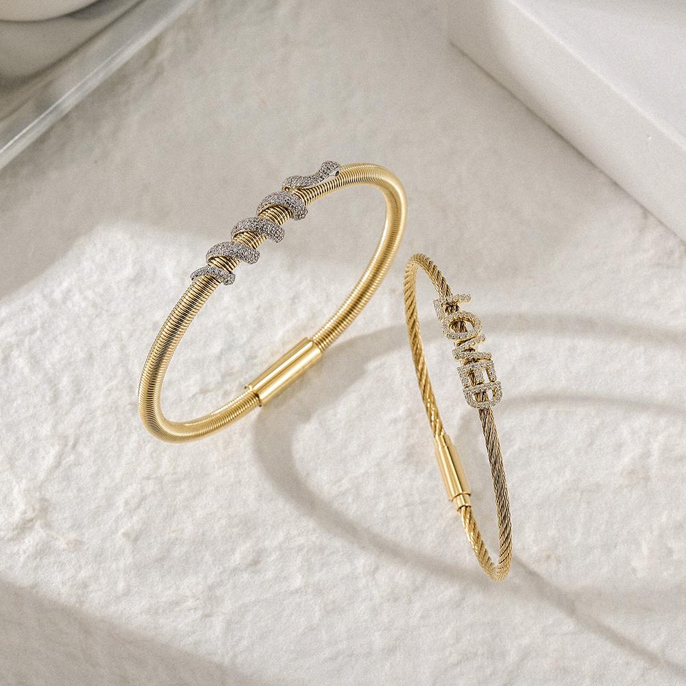 Snake Coiled Loved Pavé Bangle Set featuring cubic zirconia accents and a magnetic closure, elegantly displayed in a gift box.