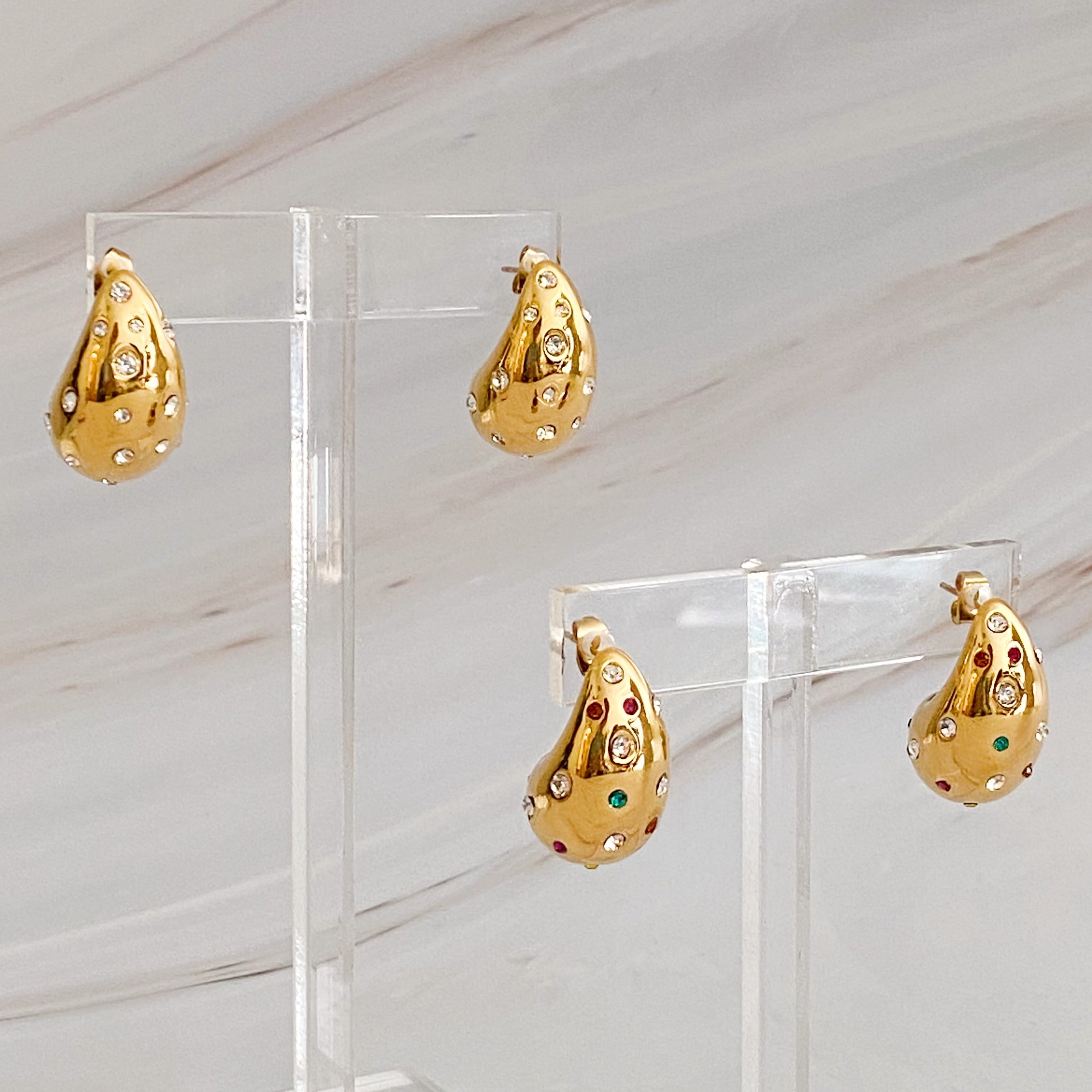 So Chic Jeweled Teardrop Earrings featuring a luxurious teardrop shape with sparkling stones, crafted from 18k gold plated stainless steel.