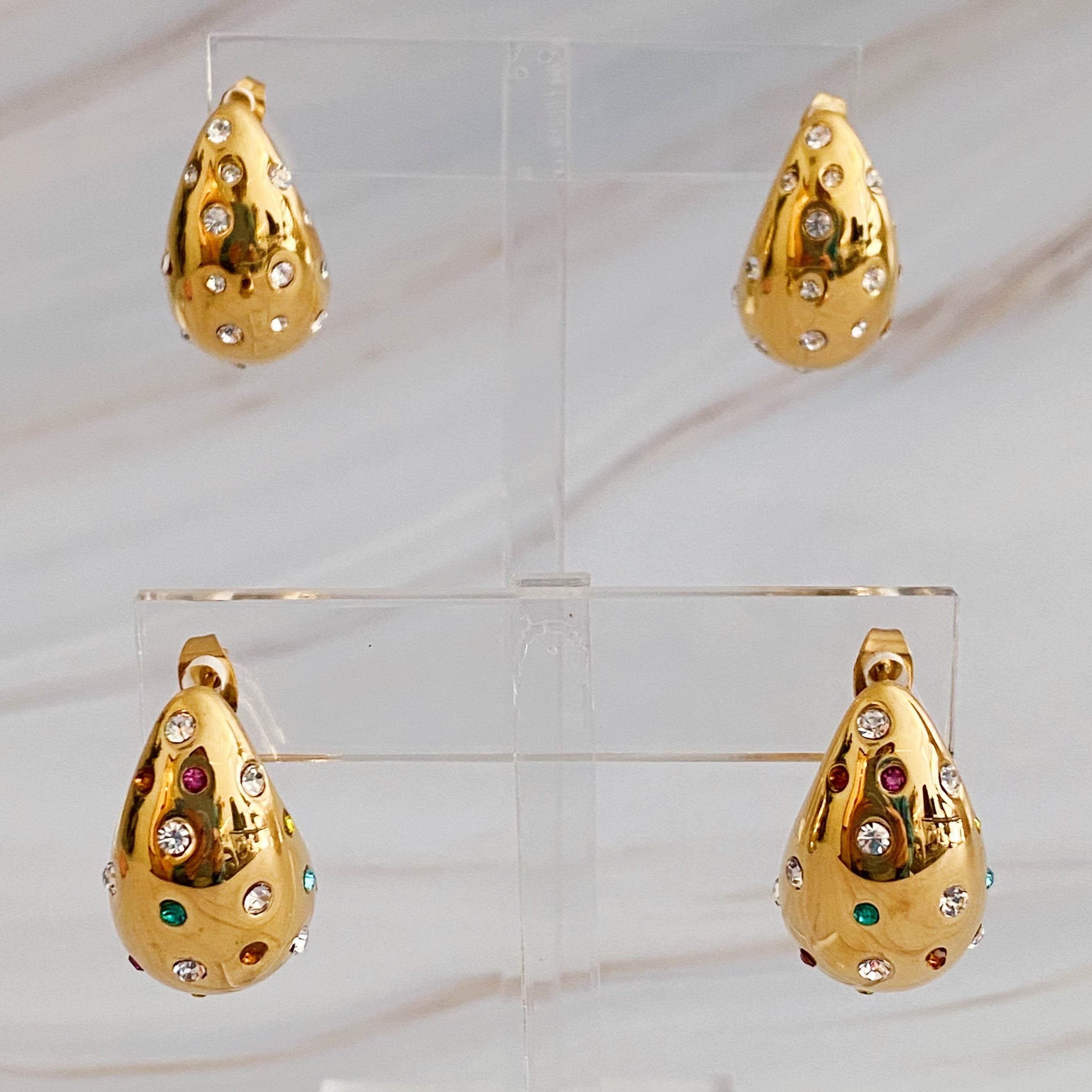 So Chic Jeweled Teardrop Earrings featuring a luxurious teardrop shape with sparkling stones, crafted from 18k gold plated stainless steel.