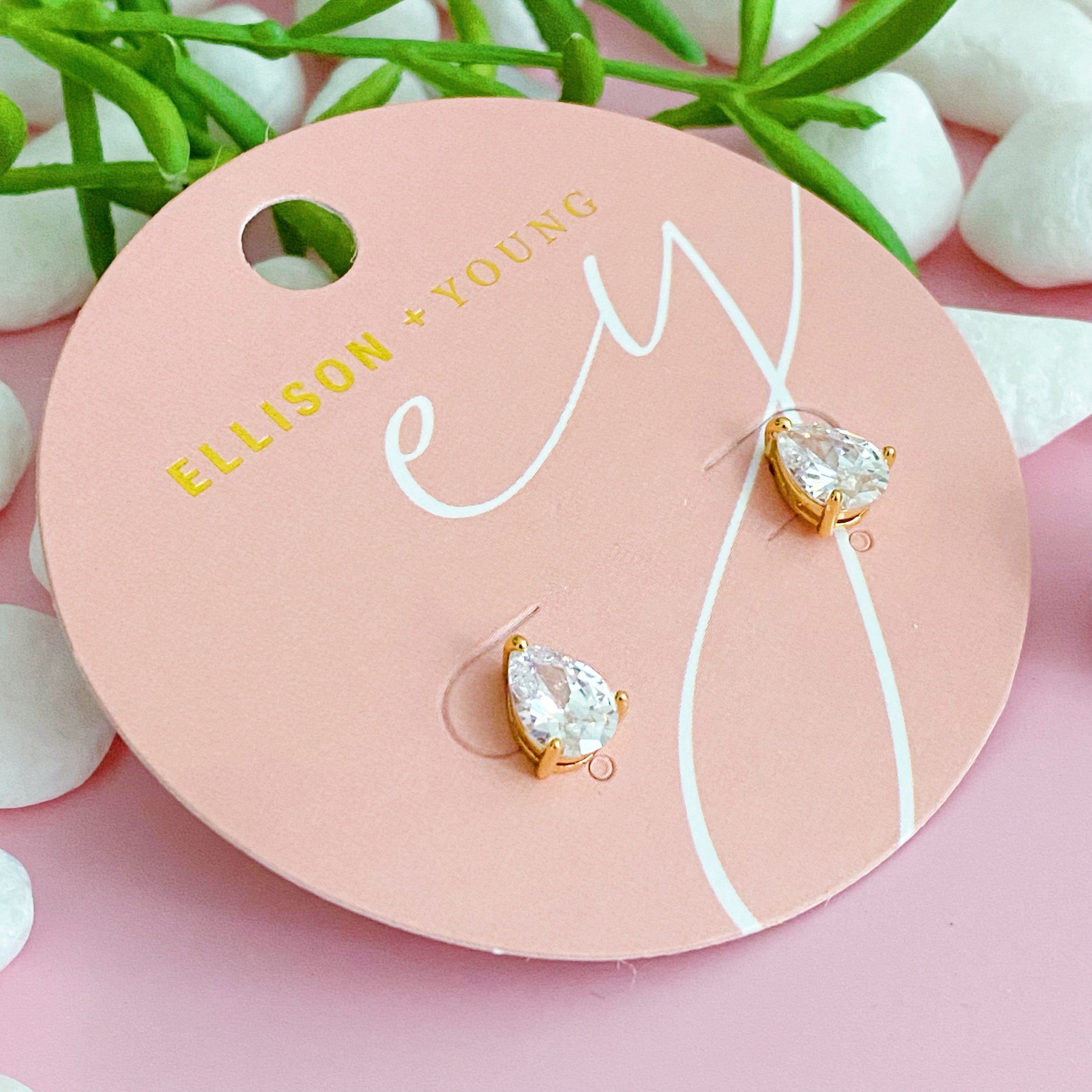 Elegant gold plated teardrop stud earrings with cubic zirconia and glass pearls, showcasing a sophisticated design.