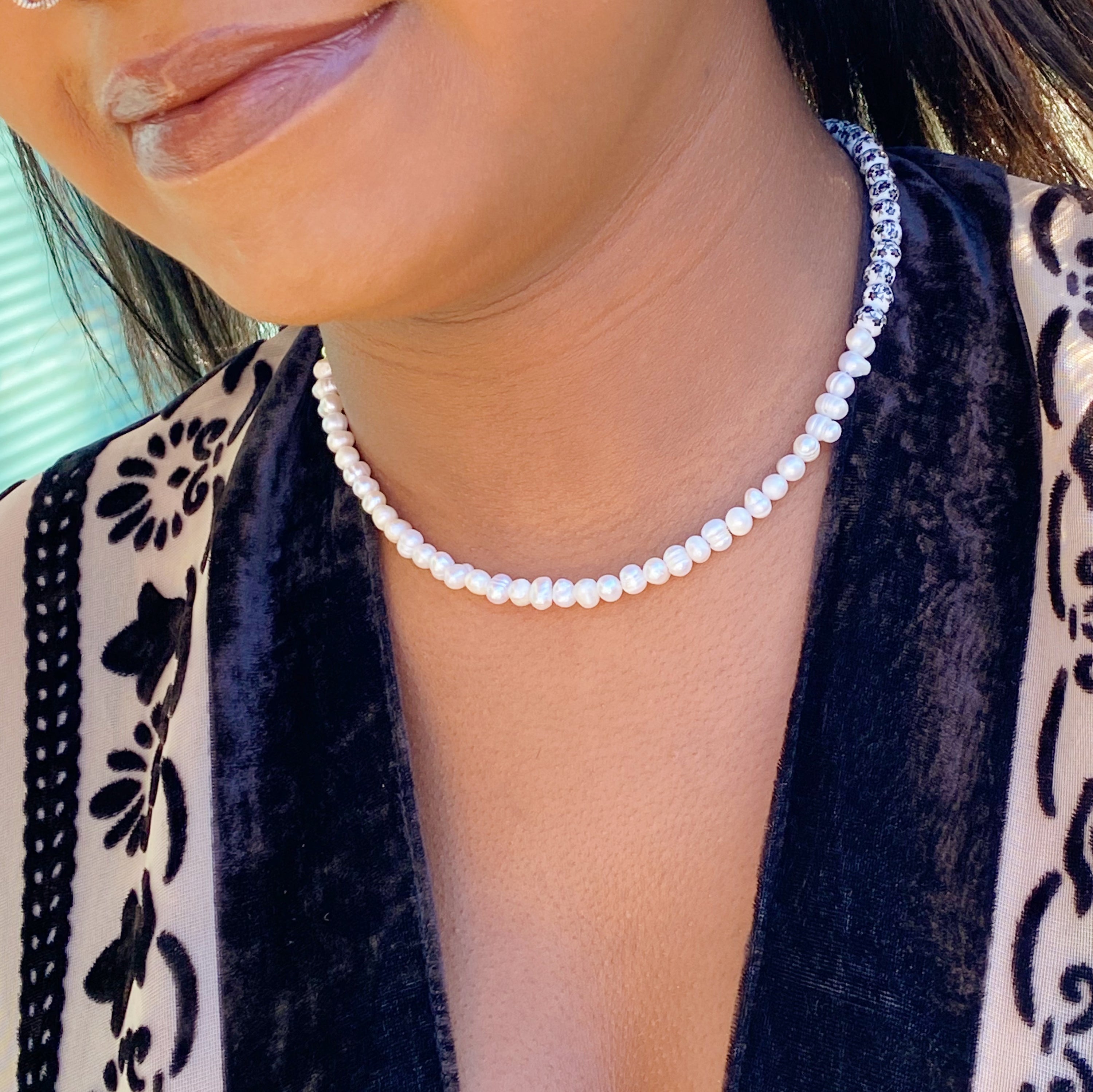 So Fresh Pearl and Porcelain Choker Necklace featuring freshwater pearls and ceramic beads, elegantly designed with gold plated stainless steel accents.