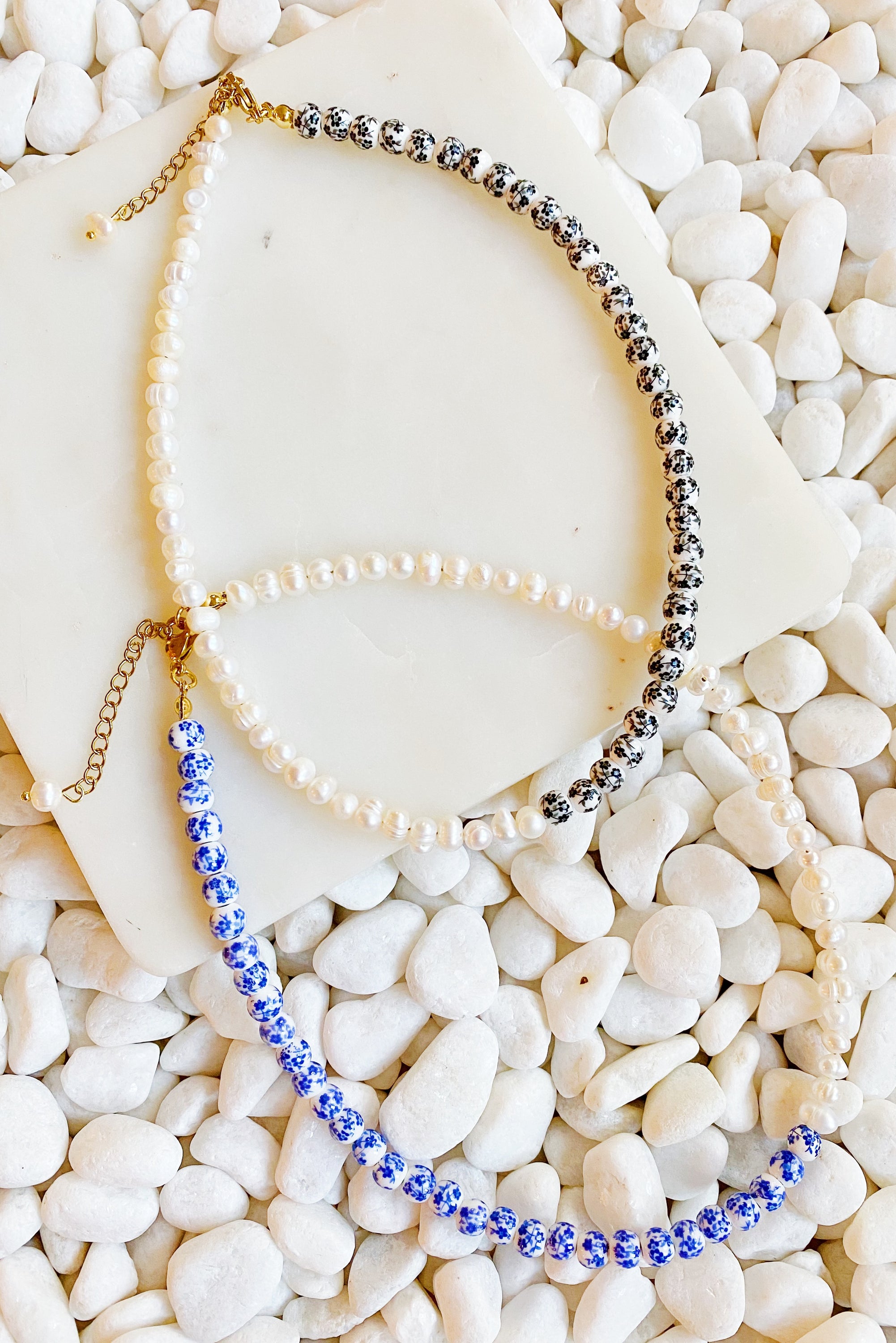 So Fresh Pearl and Porcelain Choker Necklace featuring freshwater pearls and ceramic beads, elegantly designed with gold plated stainless steel accents.