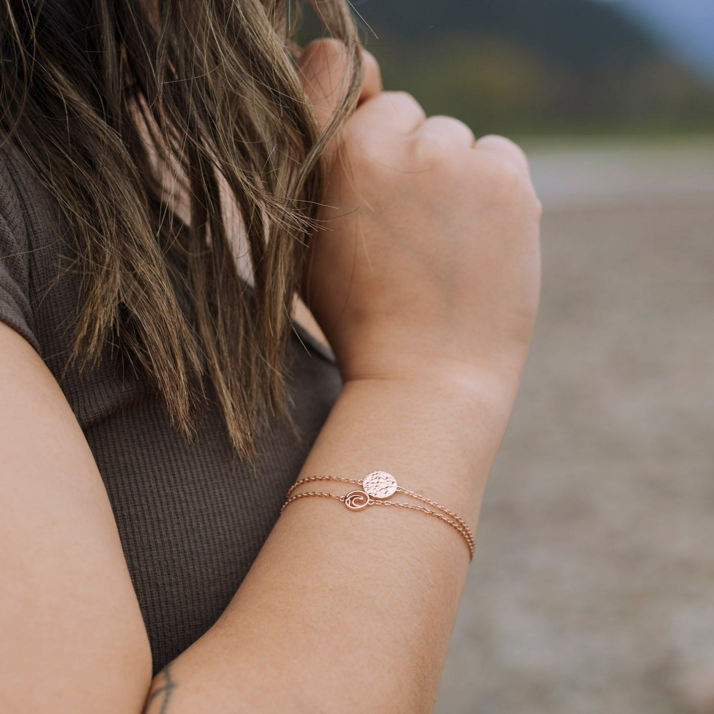 Sol Adjustable Bracelet featuring a textured circle design on an adjustable cable chain, available in sterling silver with three finishes.