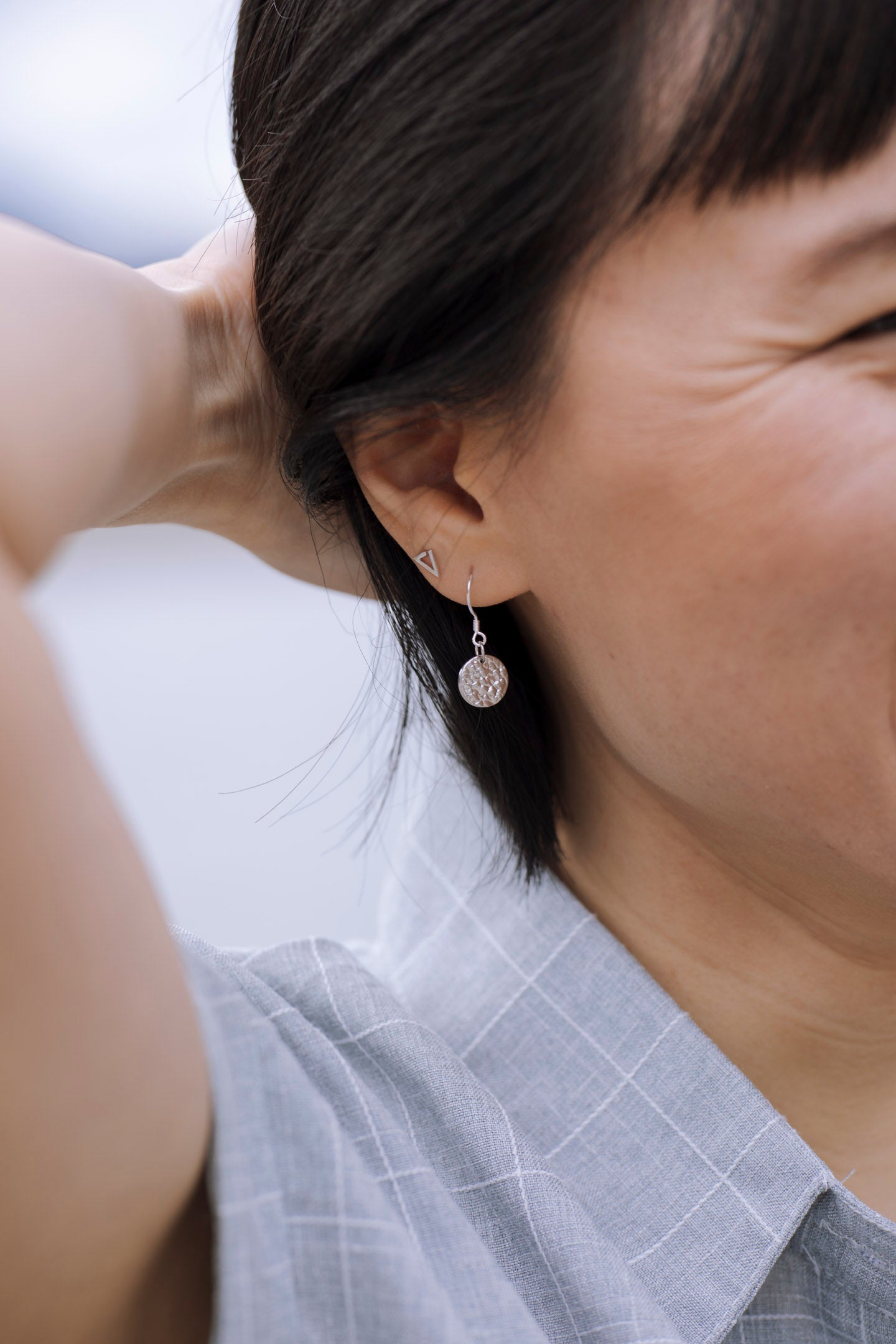 Elegant Sol Texture Circle Drop Earrings in sterling silver with a textured finish, available in three stunning colors.