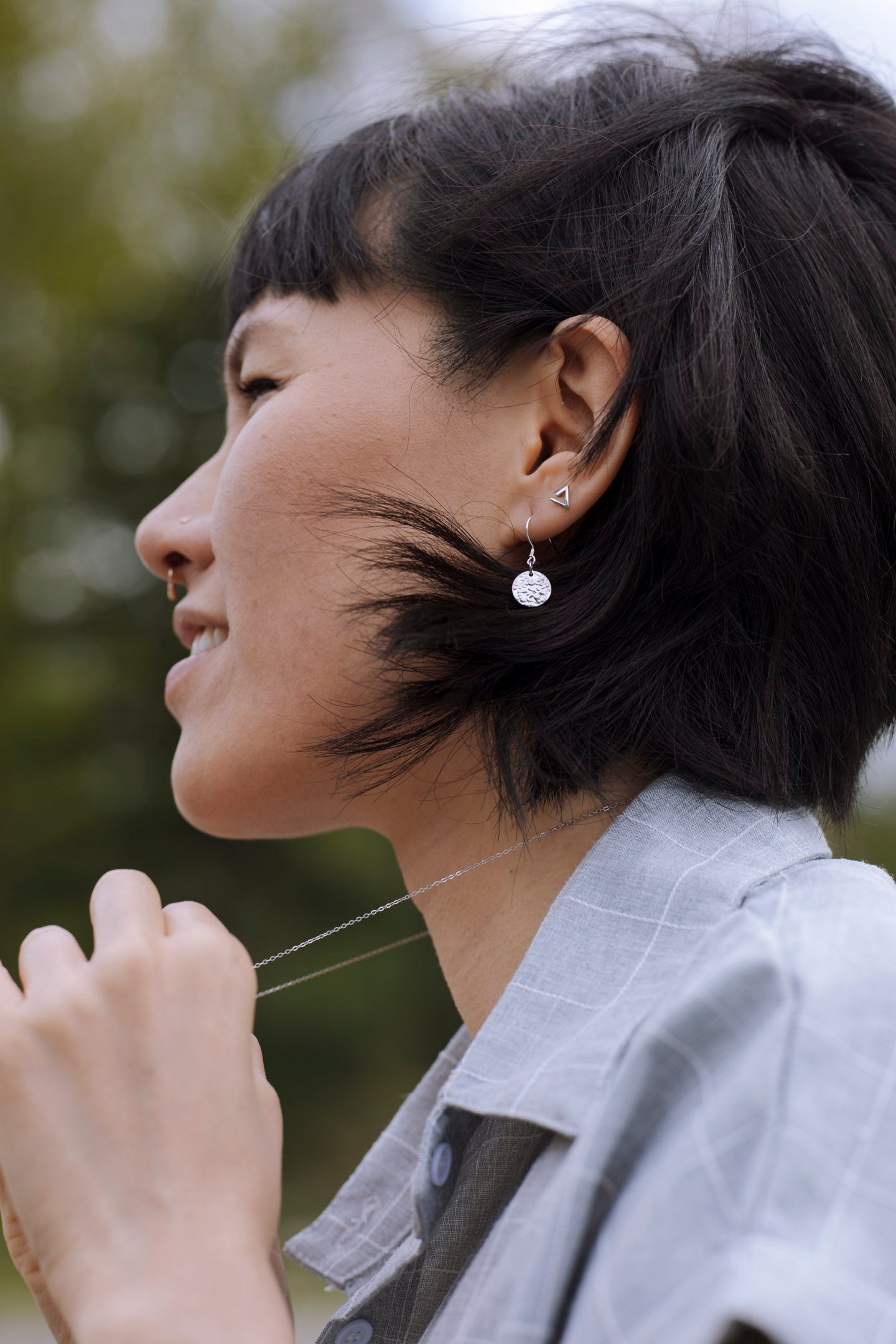 Elegant Sol Texture Circle Drop Earrings in sterling silver with a textured finish, available in three stunning colors.