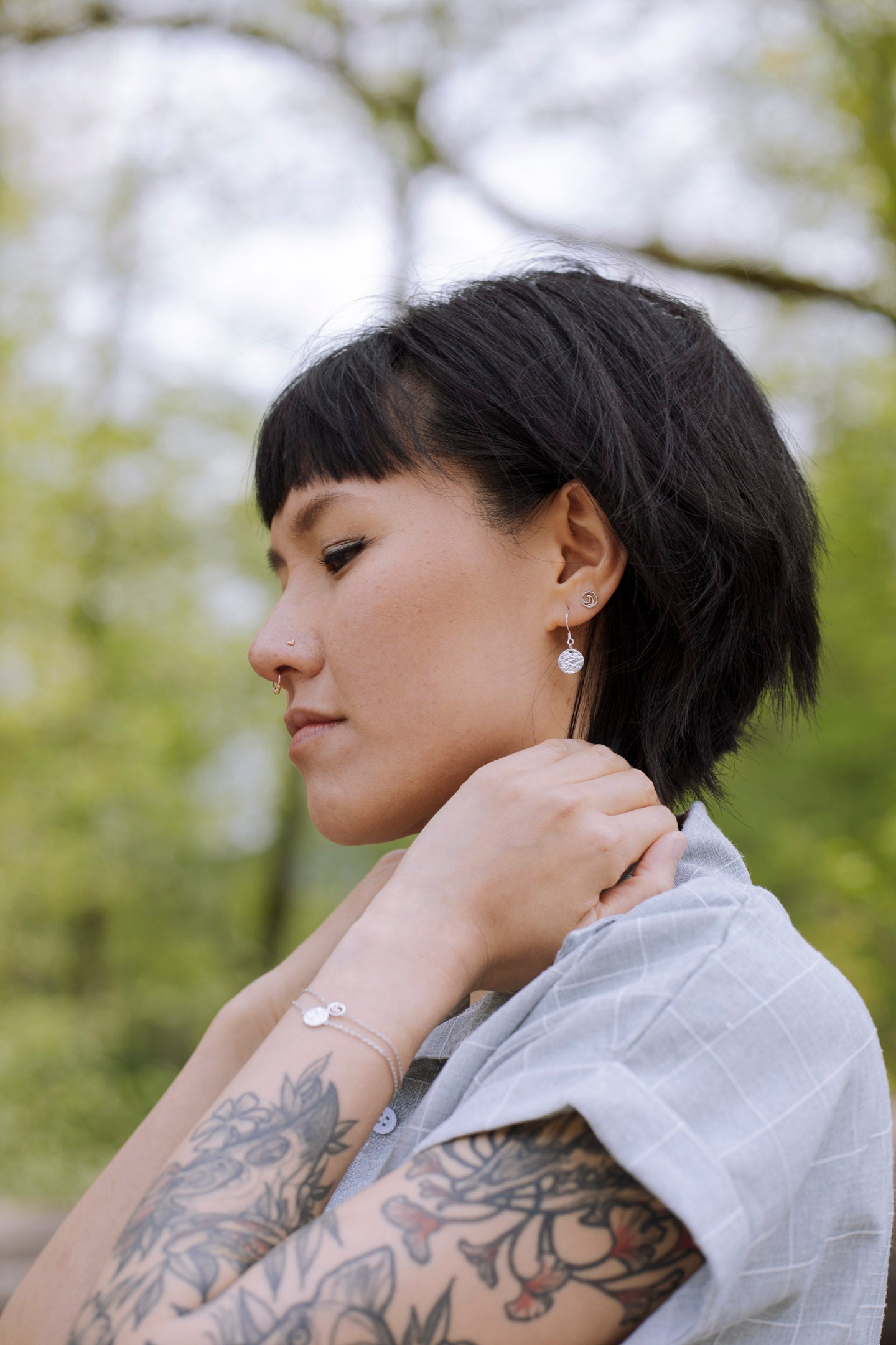 Elegant Sol Texture Circle Drop Earrings in sterling silver with a textured finish, available in three stunning colors.