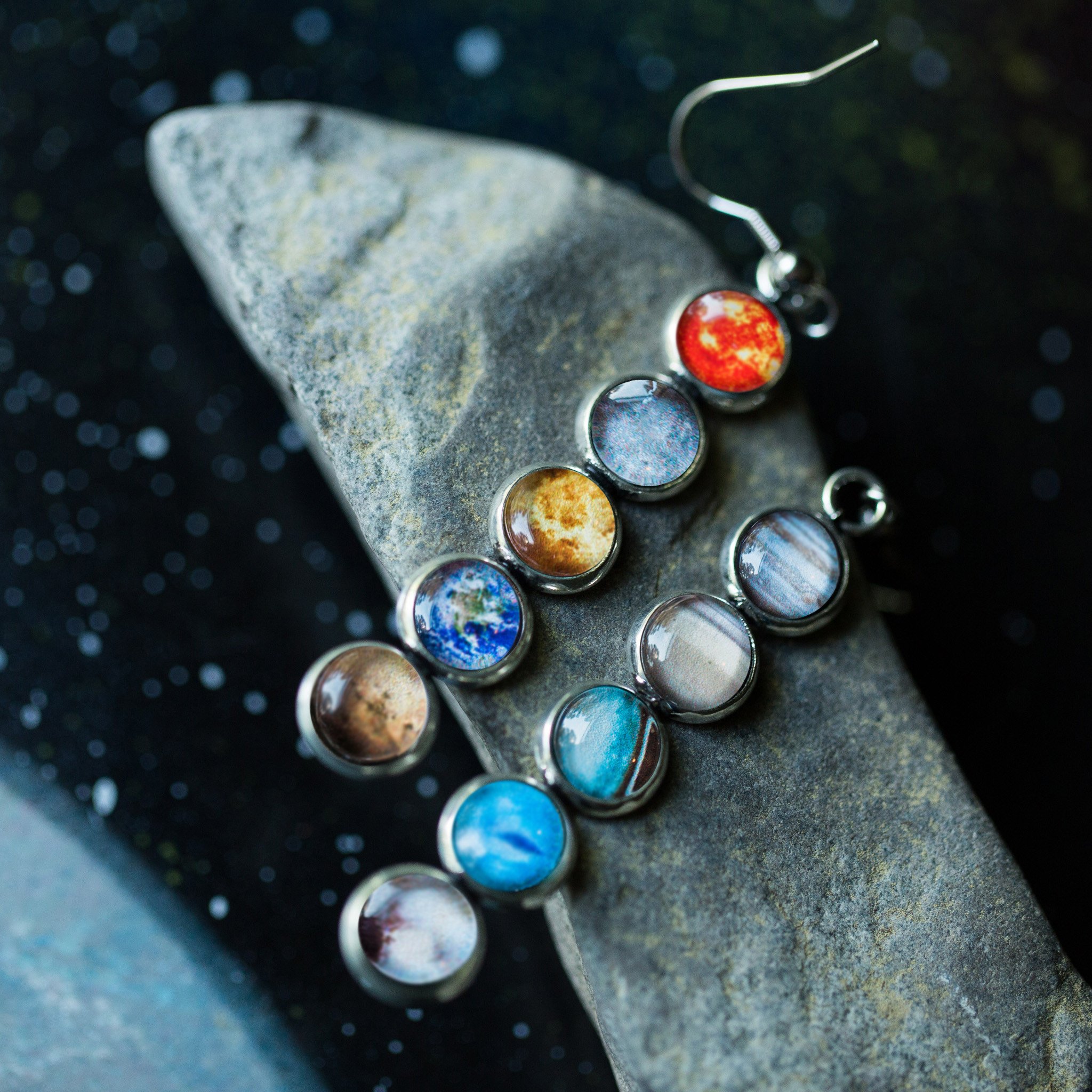 Colorful Solar System Mis-Matched Earrings featuring planets and the Sun in silver-tone bezels, hanging from French hooks.