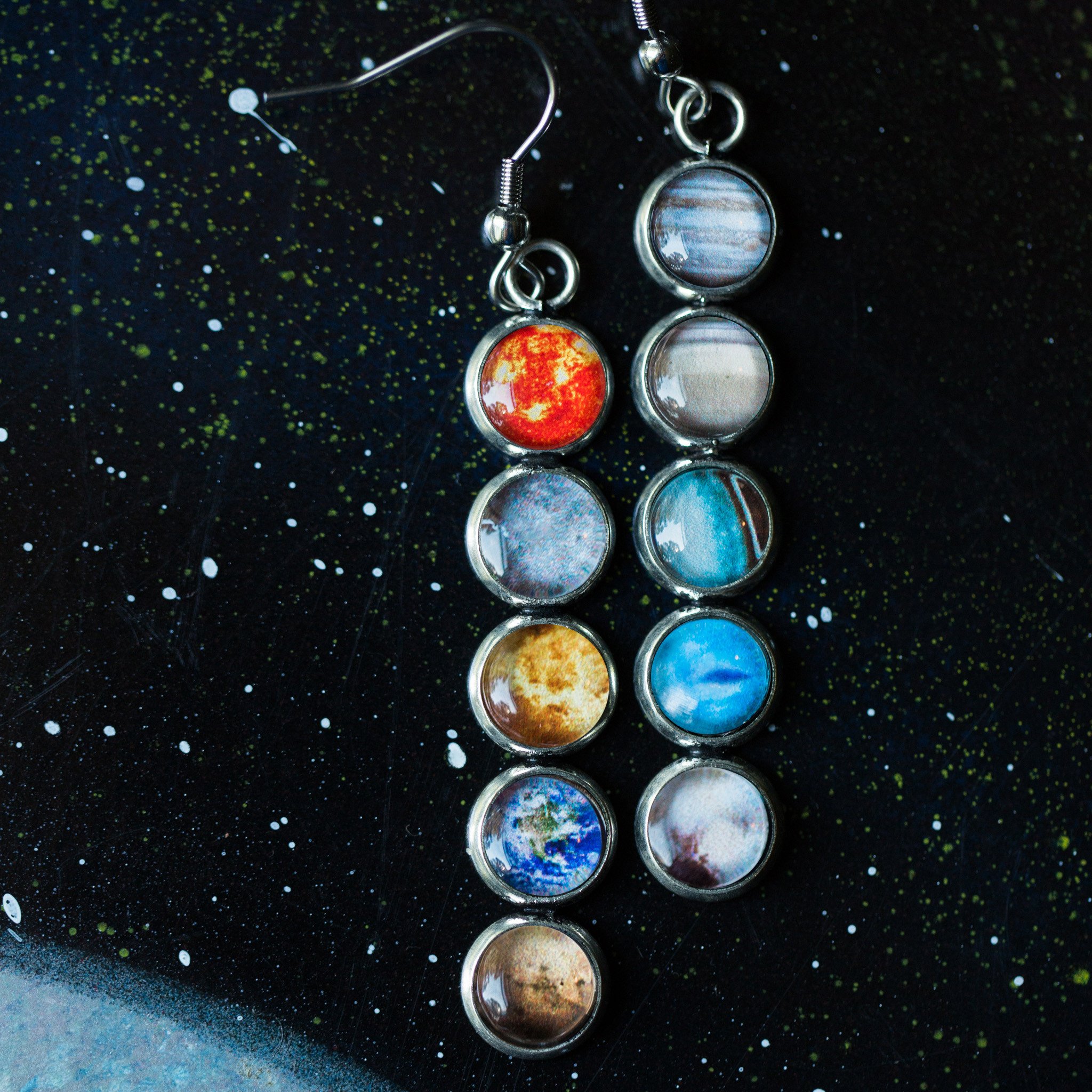 Colorful Solar System Mis-Matched Earrings featuring planets and the Sun in silver-tone bezels, hanging from French hooks.