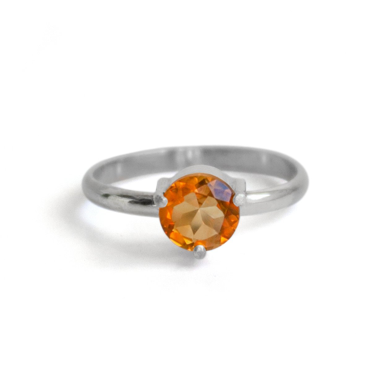 A stunning solitaire citrine ring featuring a 6mm round brilliant citrine stone set in a three prong sterling silver band.