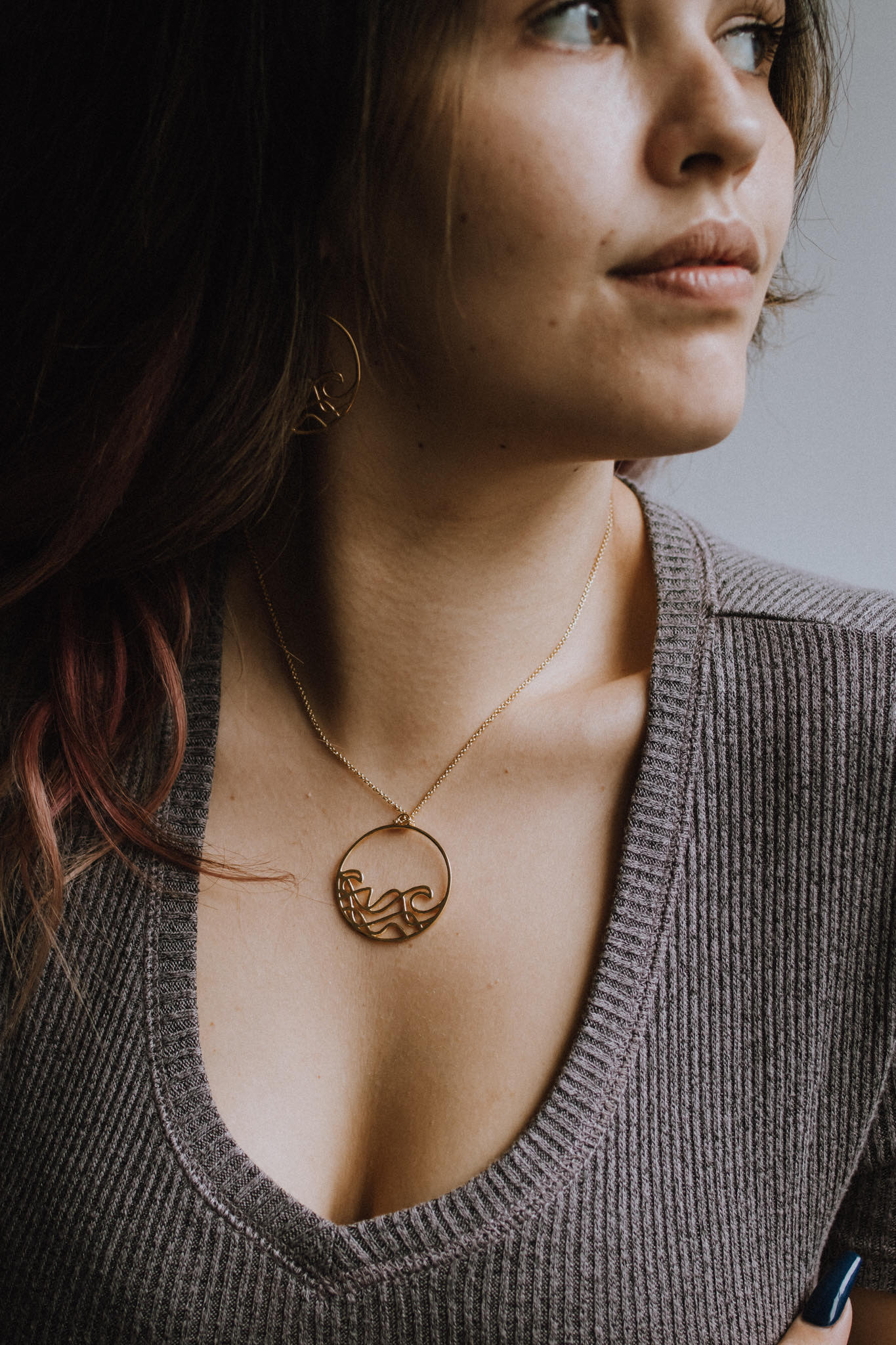 Sombrio Circle Surf Wave Necklace featuring a 925 sterling silver pendant with a wave design on a sterling silver cable chain.