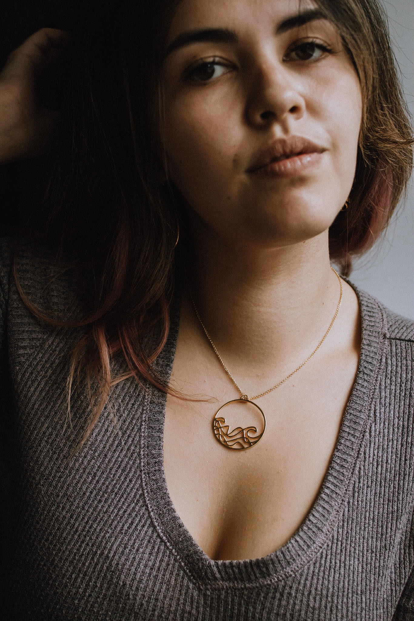 Sombrio Circle Surf Wave Necklace featuring a 925 sterling silver pendant with a wave design on a sterling silver cable chain.