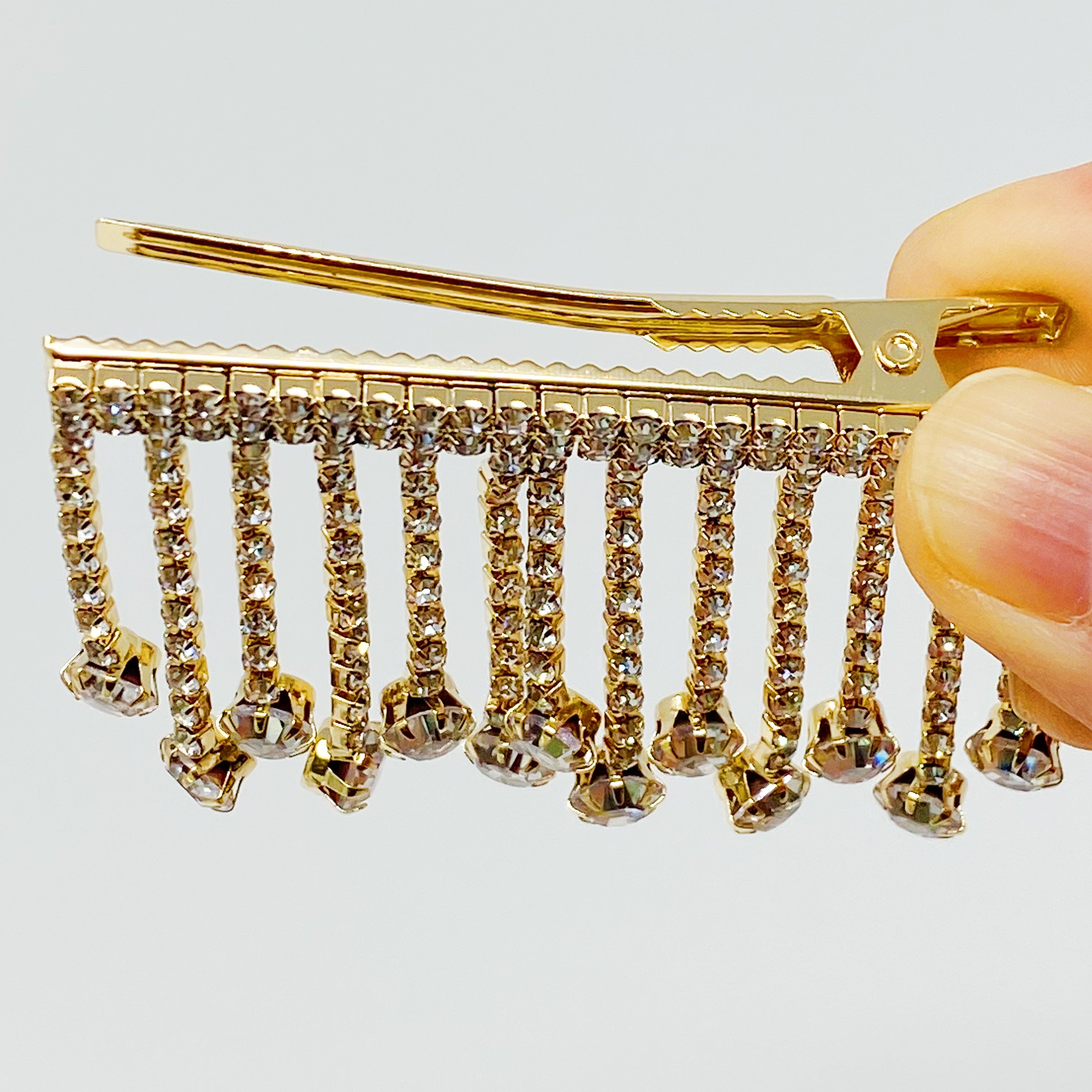 A stylish Sparkling Cascade Hair Clip featuring dangling sparkles, perfect for enhancing hairstyles.