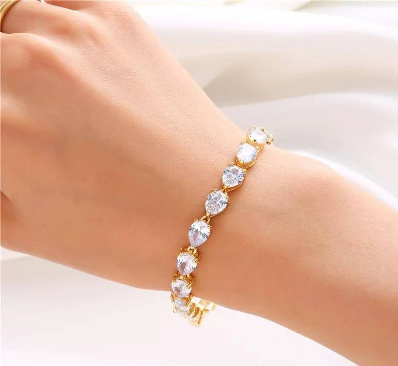 A beautiful gold-plated brass bracelet with a unique shape and secure snap closure, measuring approximately 0.3 inches wide and 7.25 inches long.