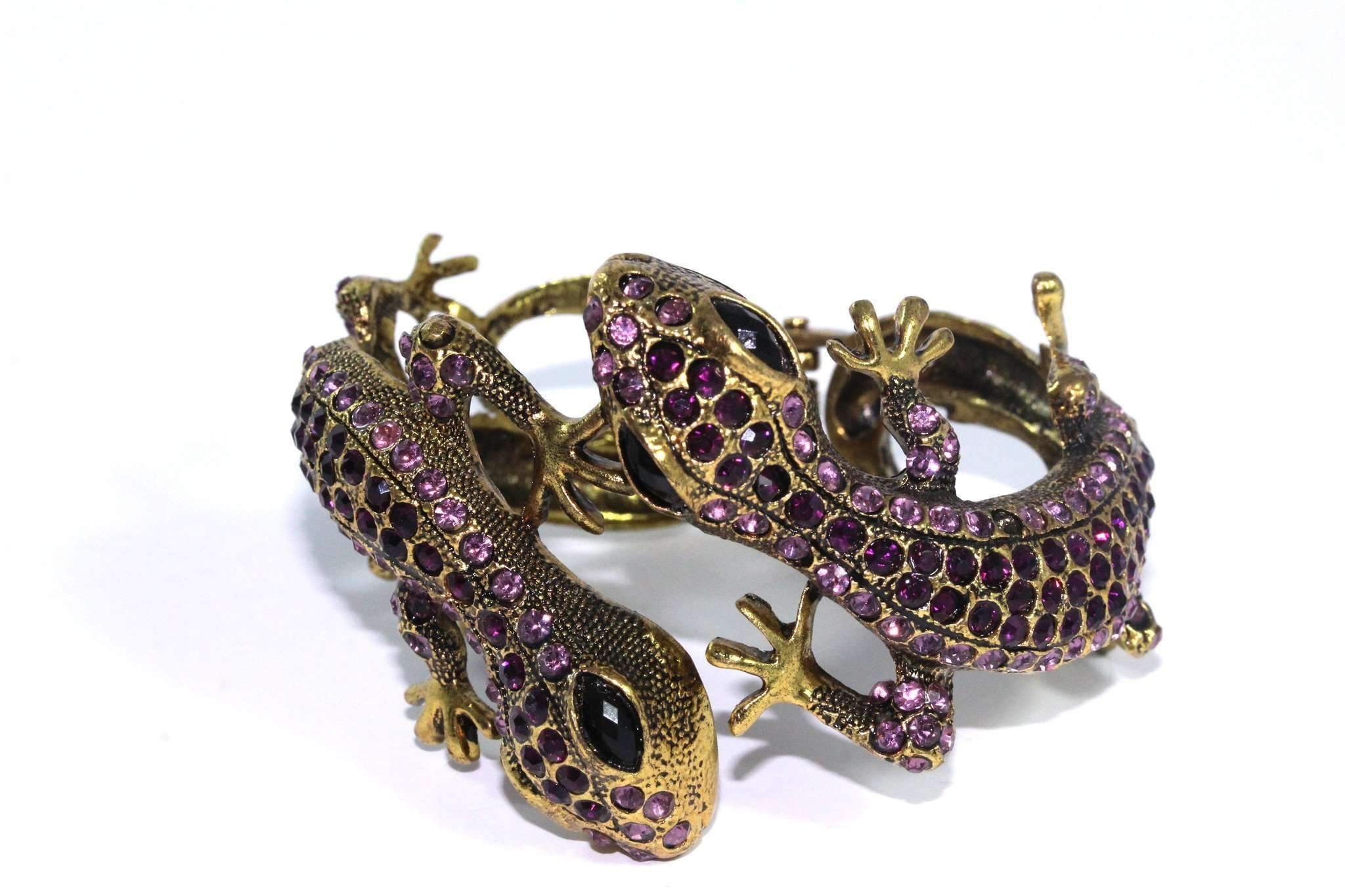 Sparkling Salamander Hinged Bangle with dark and light crystals in a gold tone finish, showcasing its elegant design.