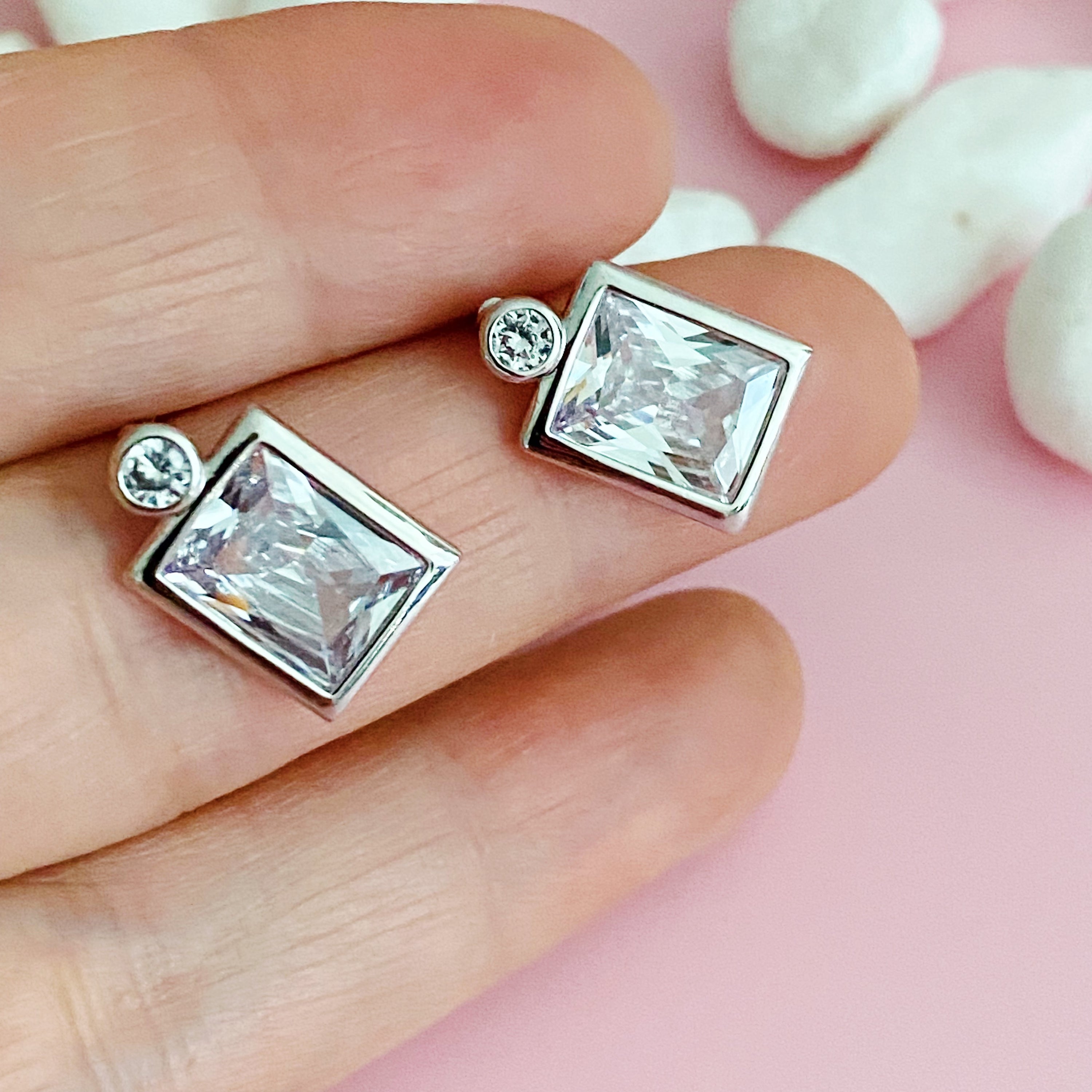 Elegant Sparkly Square Stud Earrings featuring silver-tone metal and clear cubic zirconia stones in a unique design.