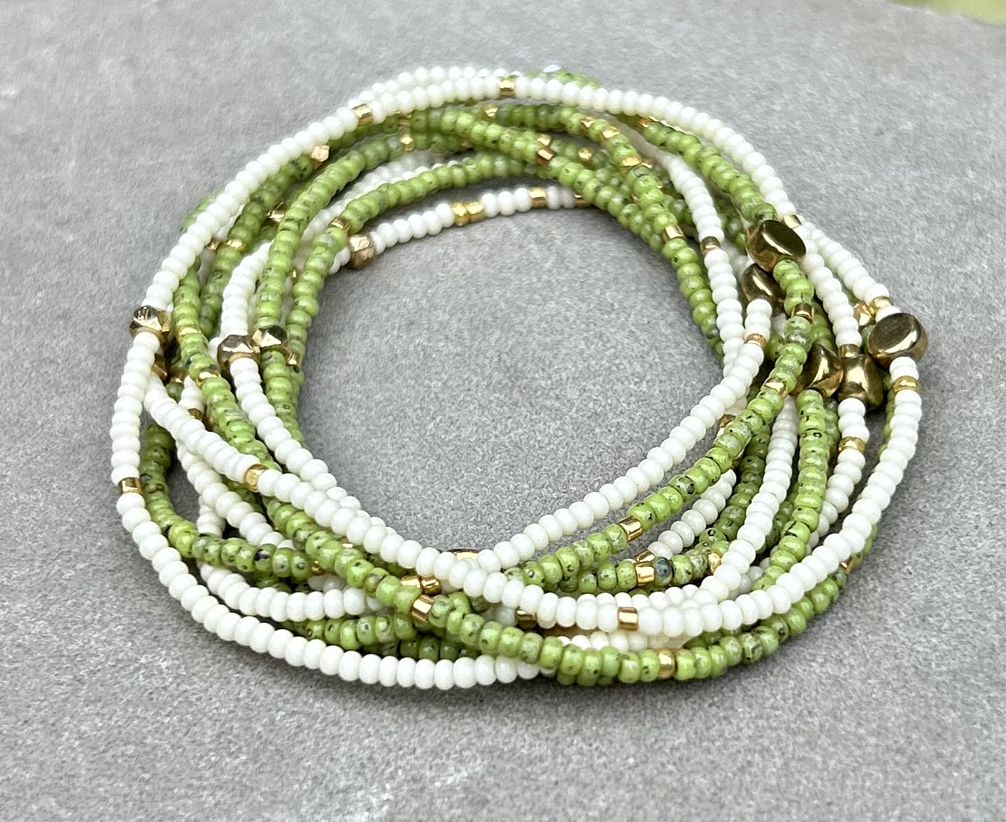 Speckled lime green and gold-sprinkled beaded 5-wrap bracelet made from MIYUKI glass seed beads, showcasing vibrant colors and elegant design.