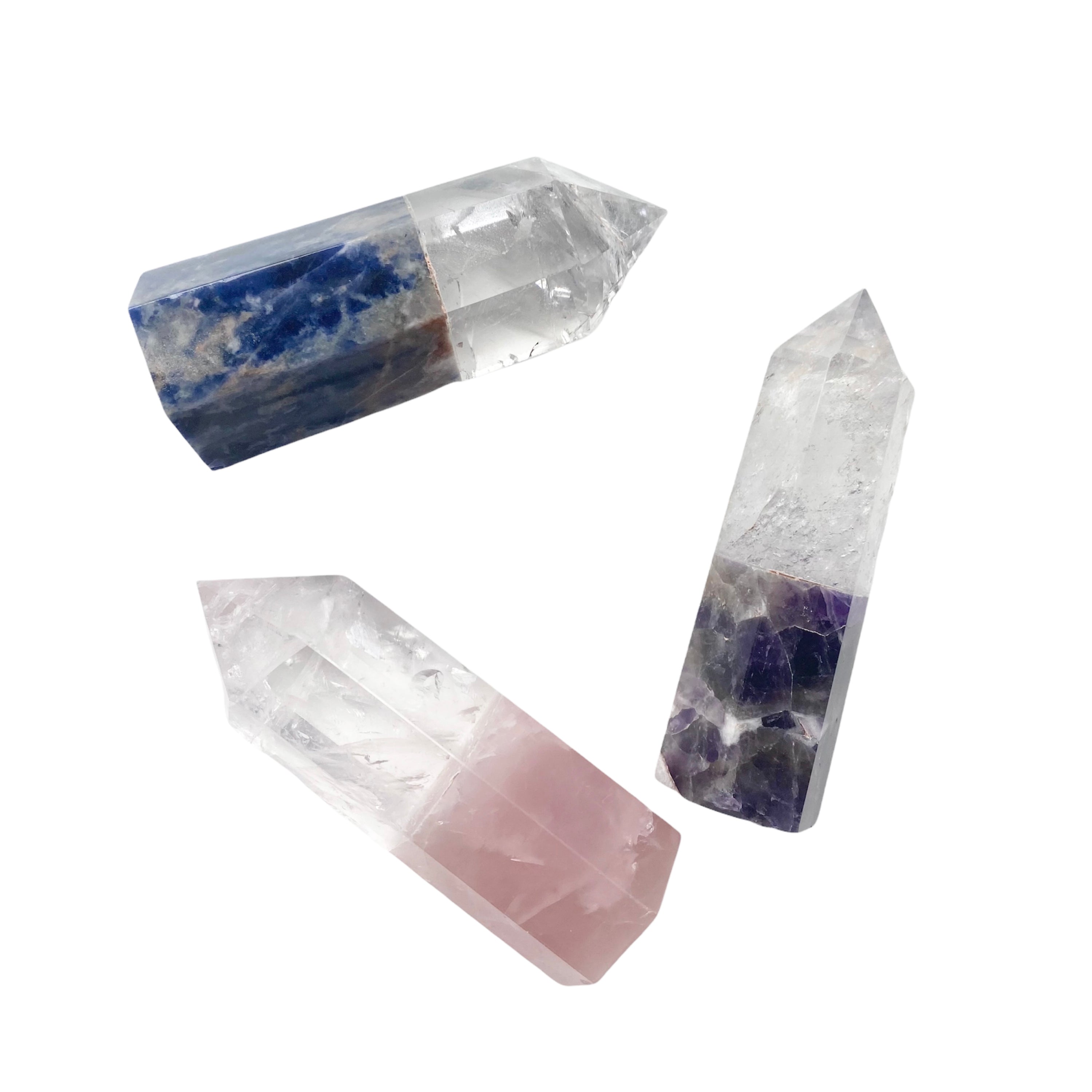 A collection of spliced crystal points featuring Clear Quartz, Rose Quartz, Sodalite, and Amethyst, showcasing their unique colors and shapes.