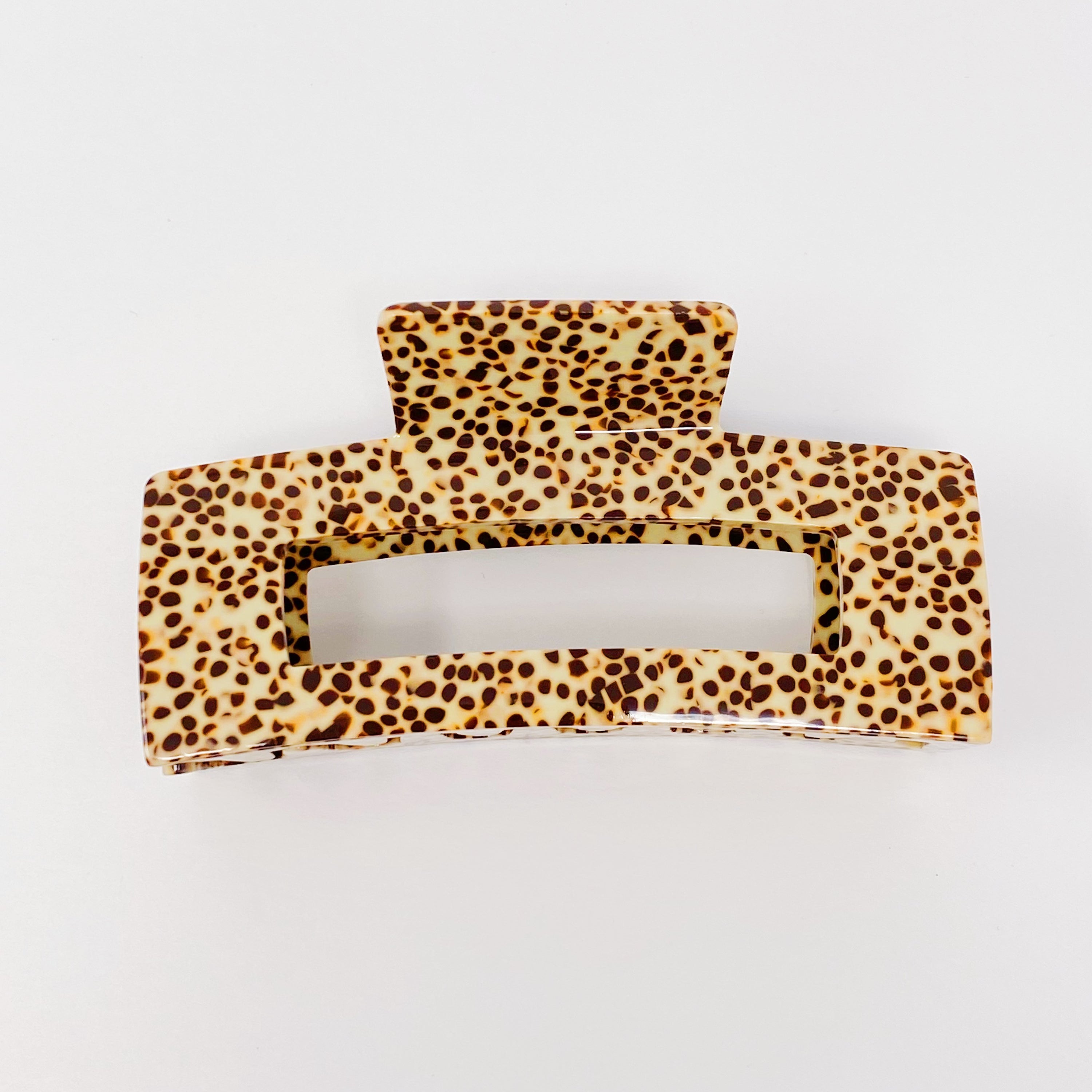 A stylish spotted print full hair claw made of high-quality acrylic, designed to hold hair securely.