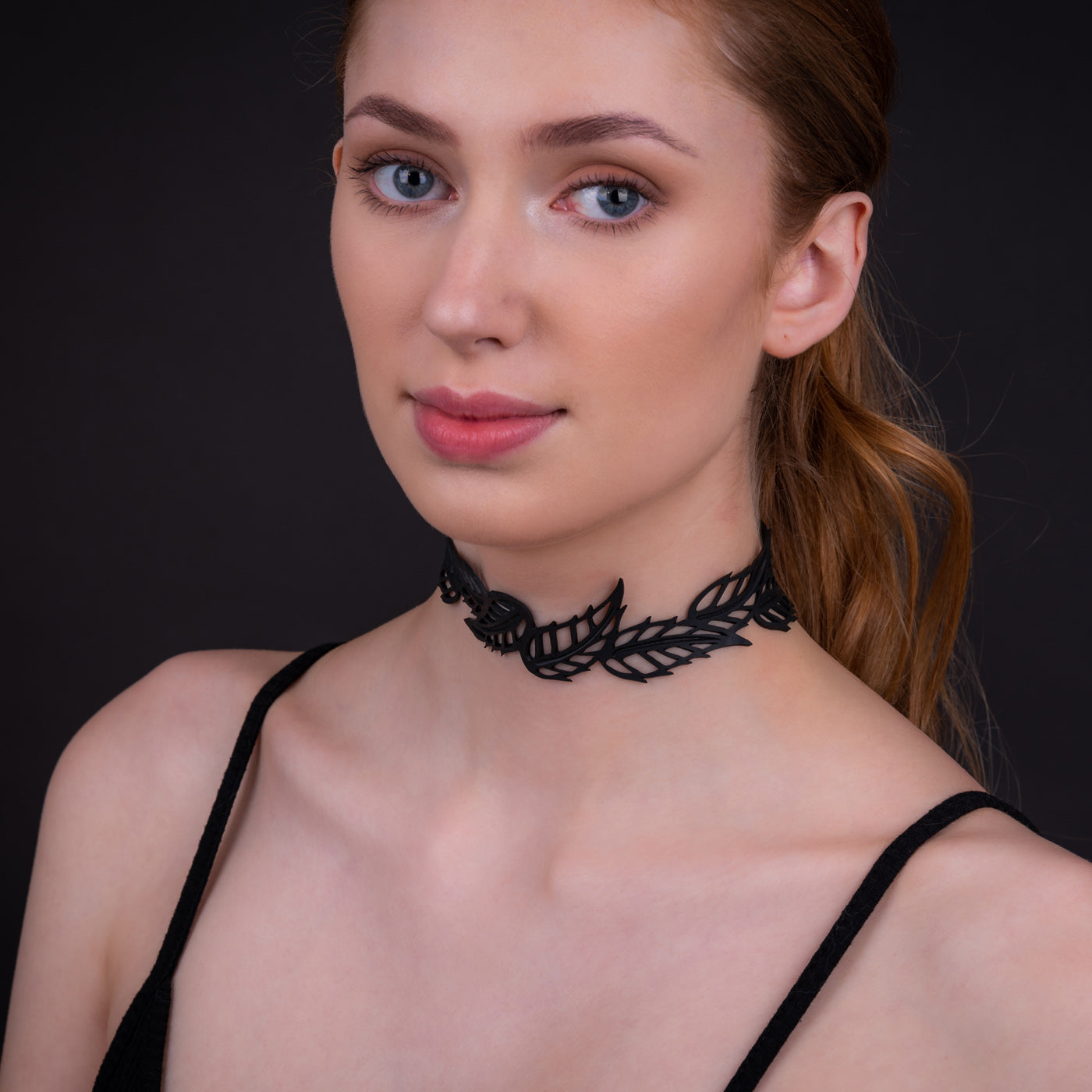 Handmade Spring Vegan Black Leaf Choker made from recycled inner tubes, featuring adjustable buttons and a unique design.