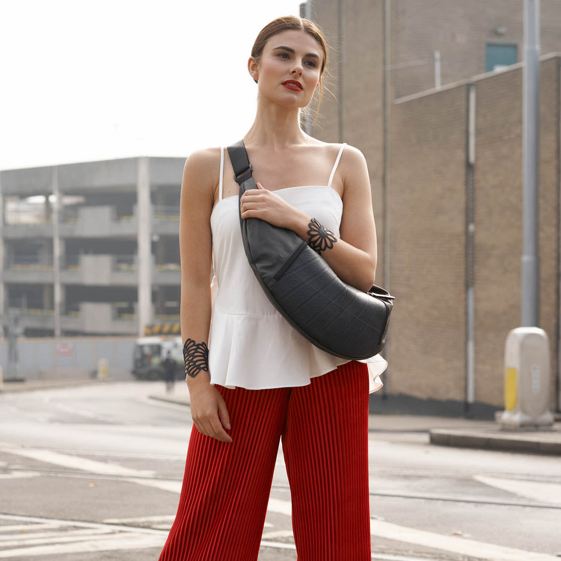 Squad Vegan Crossbody Sling Hobo Bag made from recycled rubber and military canvas, featuring adjustable strap and multiple pockets.