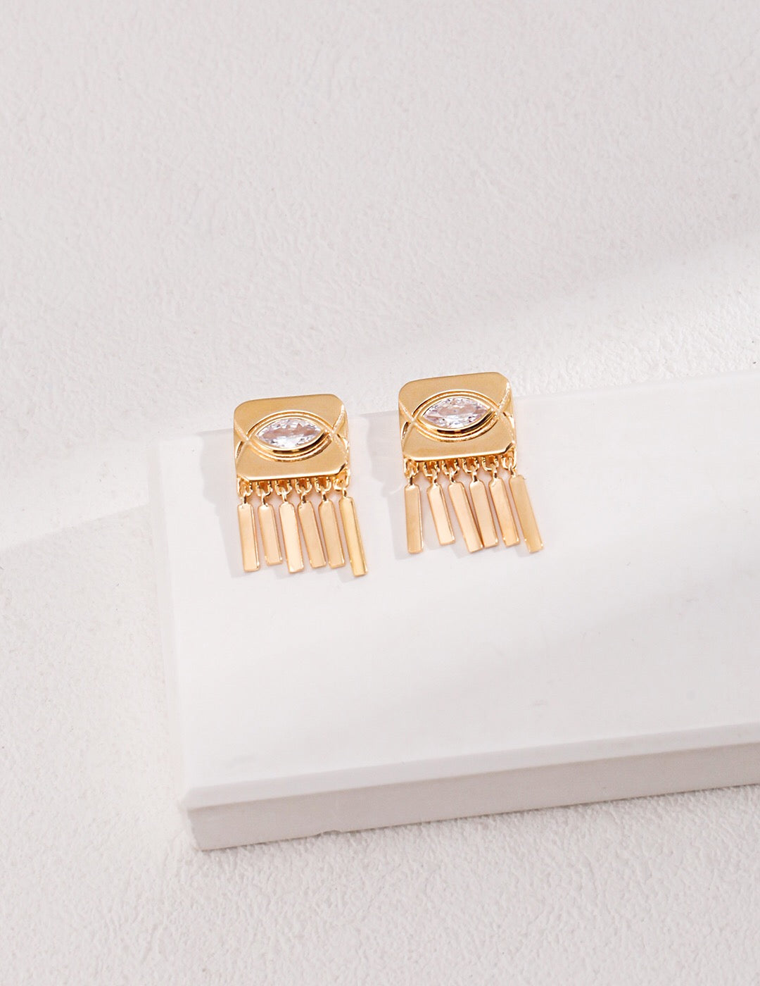 Square Eyes Zircon Tassel Stud earrings featuring zircon stones, sterling silver base, and gold vermeil plating, elegantly designed for stylish wear.