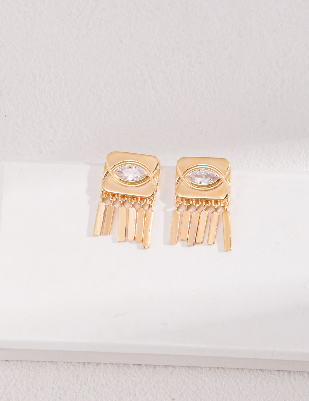 Square Eyes Zircon Tassel Stud earrings featuring zircon stones, sterling silver base, and gold vermeil plating, elegantly designed for stylish wear.