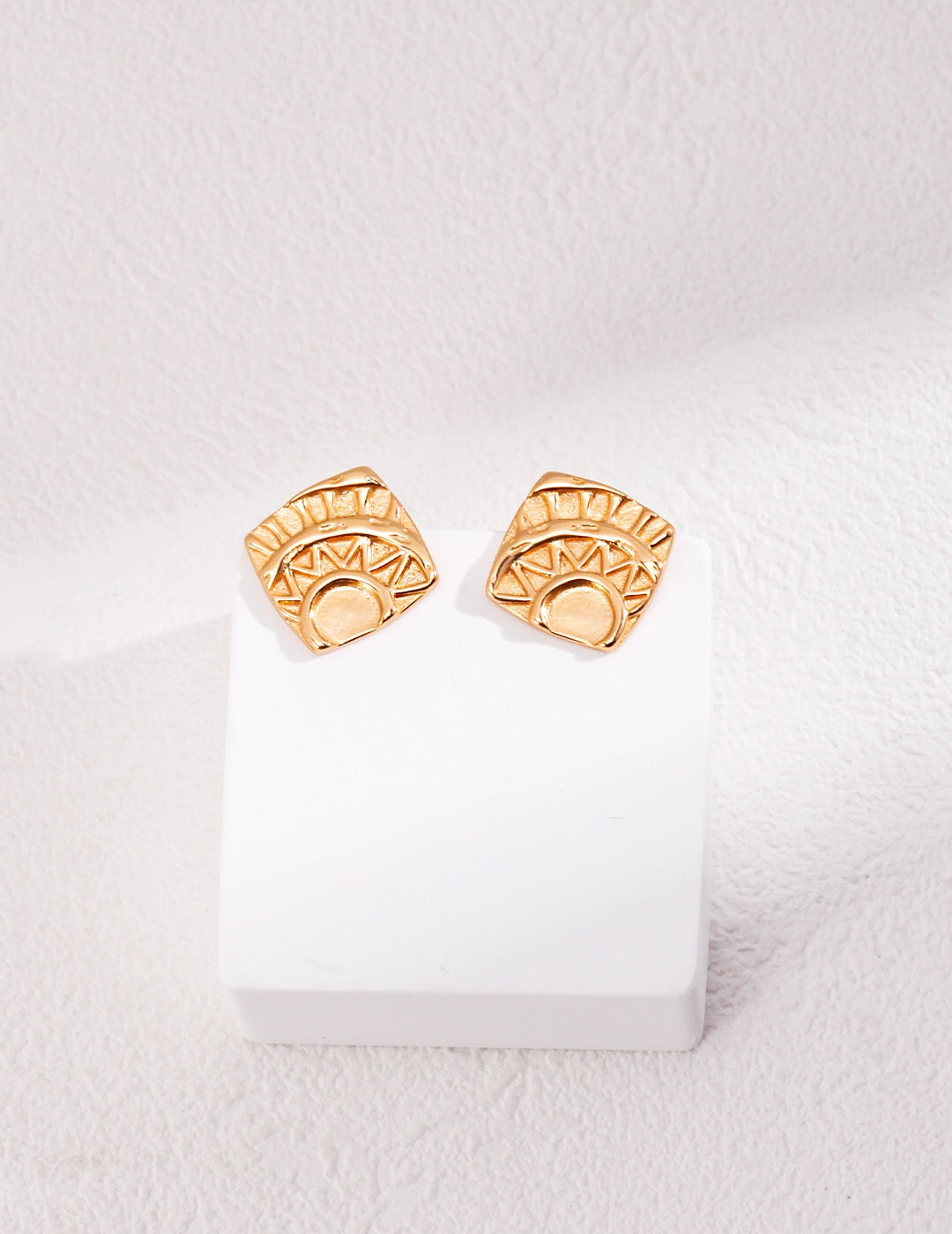 A pair of square printed stud earrings made of gold vermeil, showcasing a stylish and elegant design, perfect for any occasion.