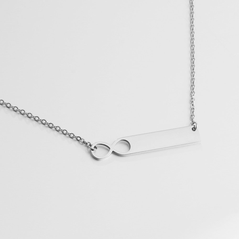 A stylish stainless steel nameplate bar necklace with a personalized pendant, showcasing its sleek design and adjustable chain.