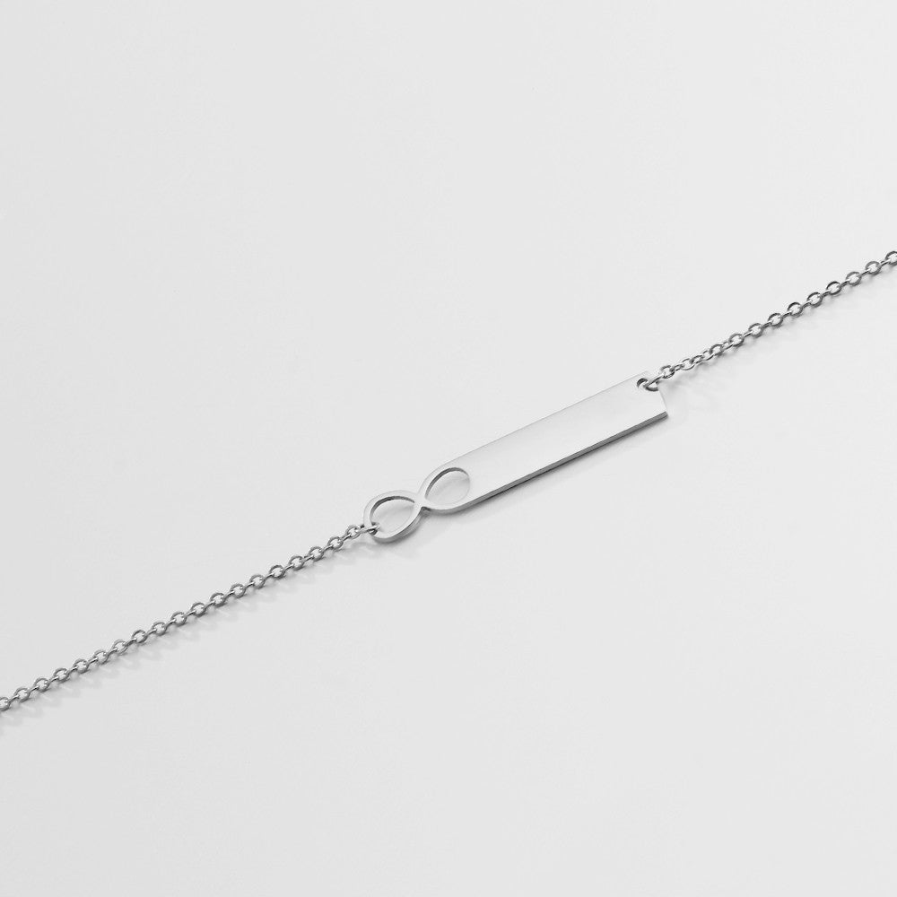 A stylish stainless steel nameplate bar necklace with a personalized pendant, showcasing its sleek design and adjustable chain.