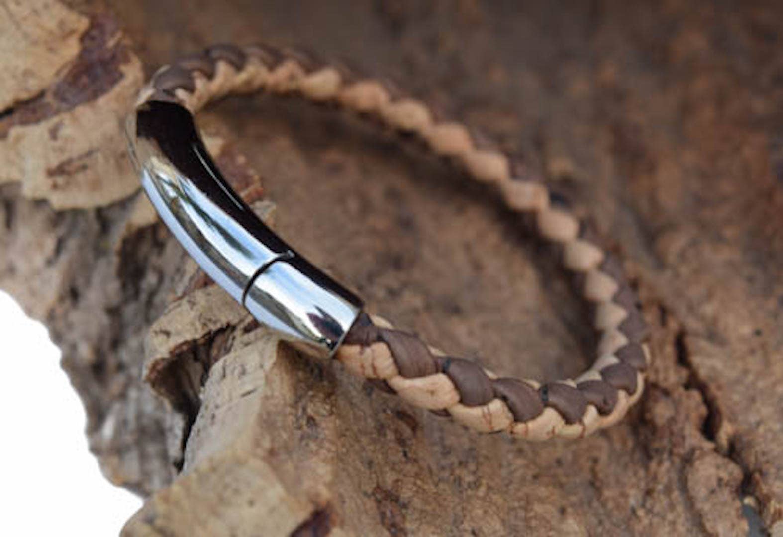 A stylish stainless steel weaved cork bracelet featuring a magnetic clasp, showcasing natural and brown cork materials.