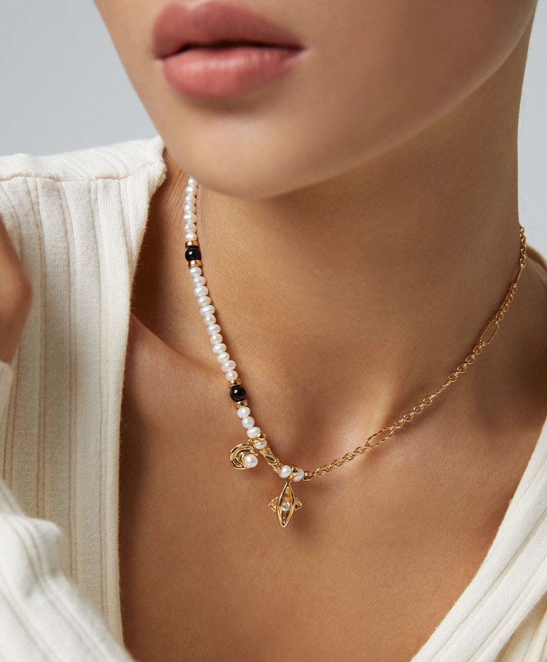 Star and Moon Design Pearl Necklace featuring natural pearls, black agate, and gold vermeil, elegantly displayed on a soft background.