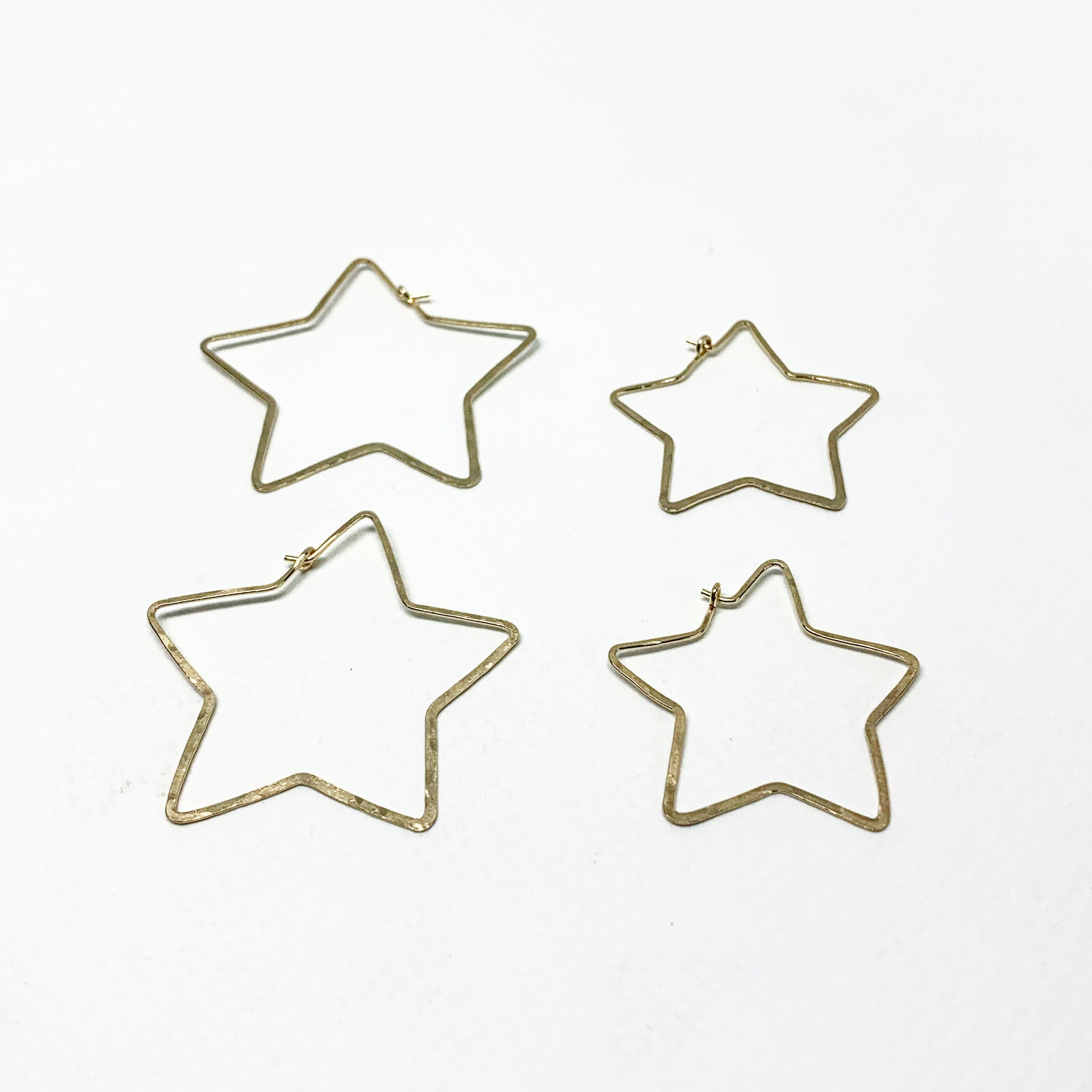 Handcrafted large star-shaped hoops made from 20 gauge wire, featuring a hammered texture and available in silver, yellow gold fill, or rose gold fill.