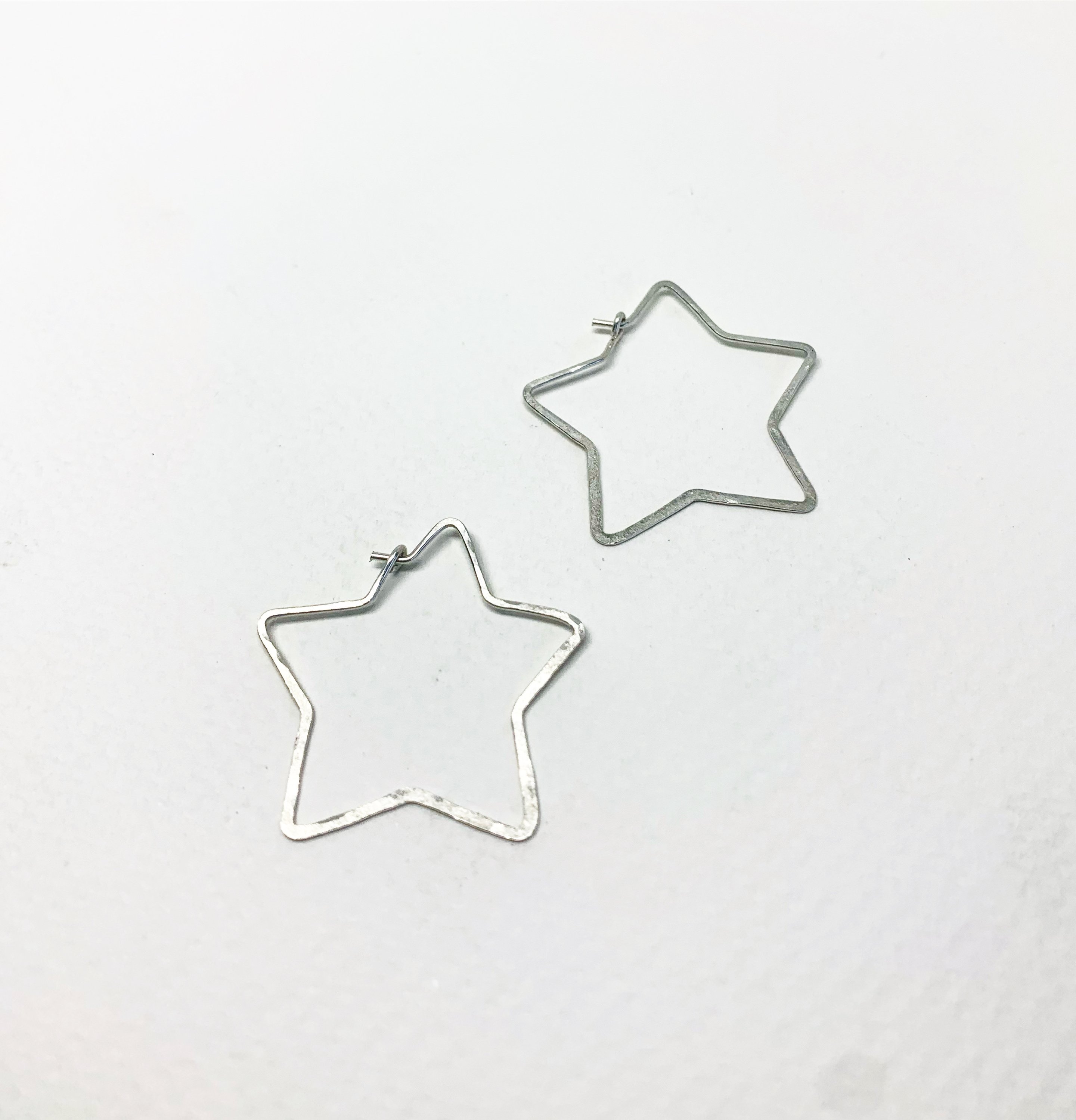 Handmade star-shaped hoops made from 20 gauge wire, featuring a hammered texture and available in silver, yellow gold fill, or rose gold fill.