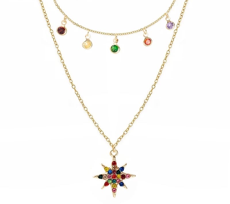 A layered star necklace adorned with rainbow cubic zirconia stones, featuring a gold-plated finish and adjustable chain.