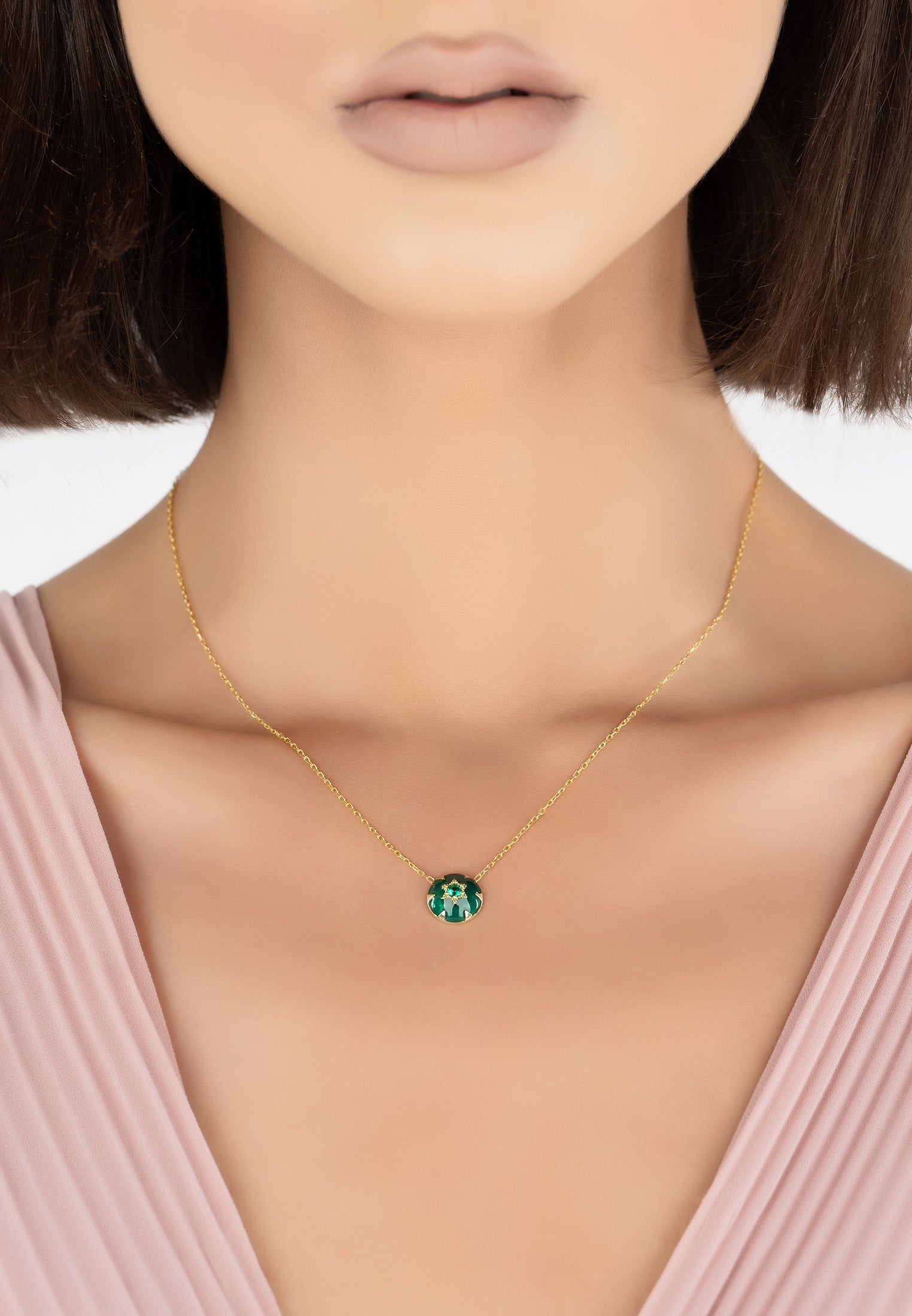 Elegant Star of David necklace featuring green enamel and gold, with emerald zircon centerpiece.