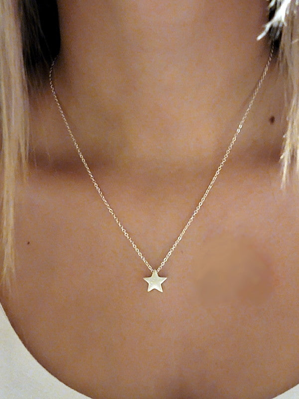 A dainty silver star pendant necklace, elegantly designed with a simple star charm, perfect for layering or wearing alone.