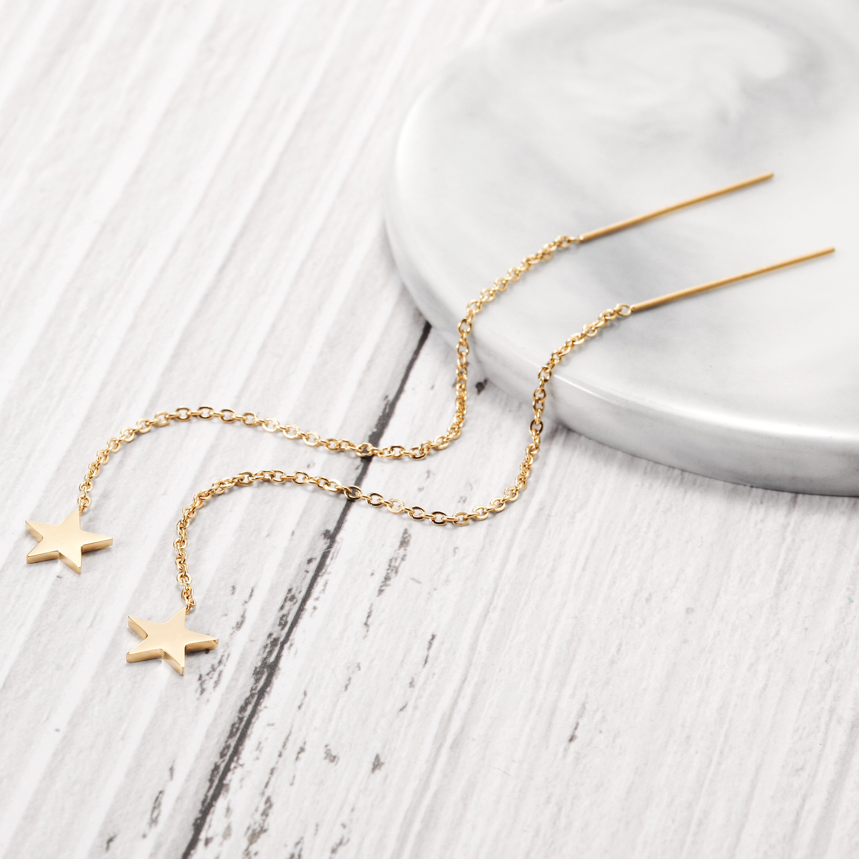 Elegant STAR THREADER EARRINGS made from hypoallergenic stainless steel with gold plating.