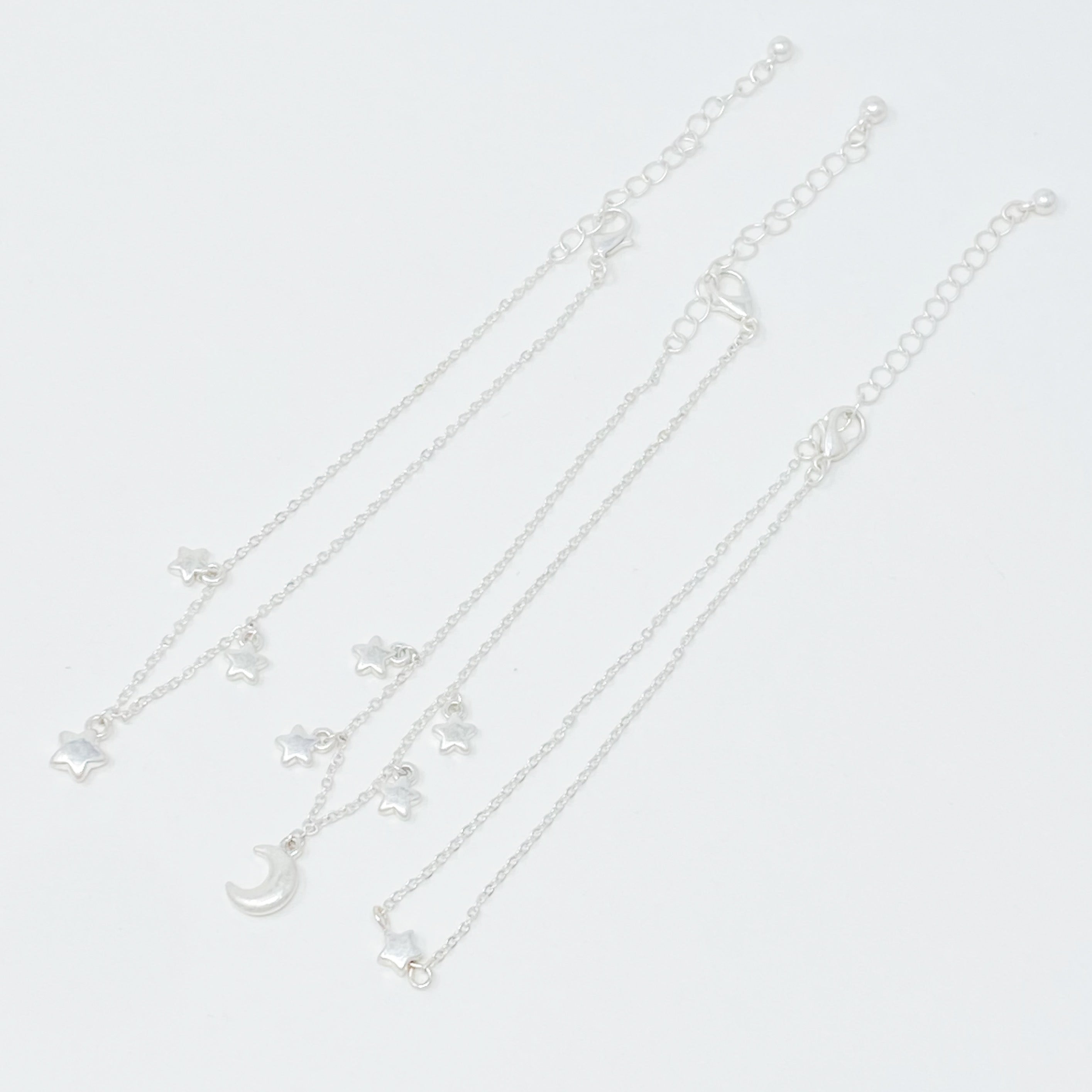 Set of 3 Starred Up Chain Anklets with star charms, showcasing a worn gold finish and adjustable chains.